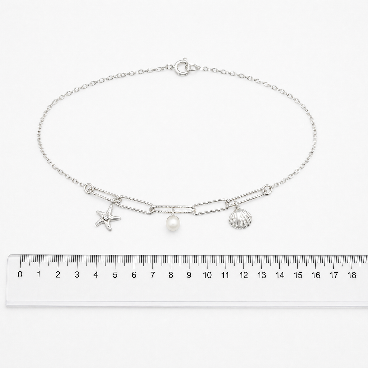 925 sterling silver shell and starfish bracelet showing its delicate chain and charms showing size