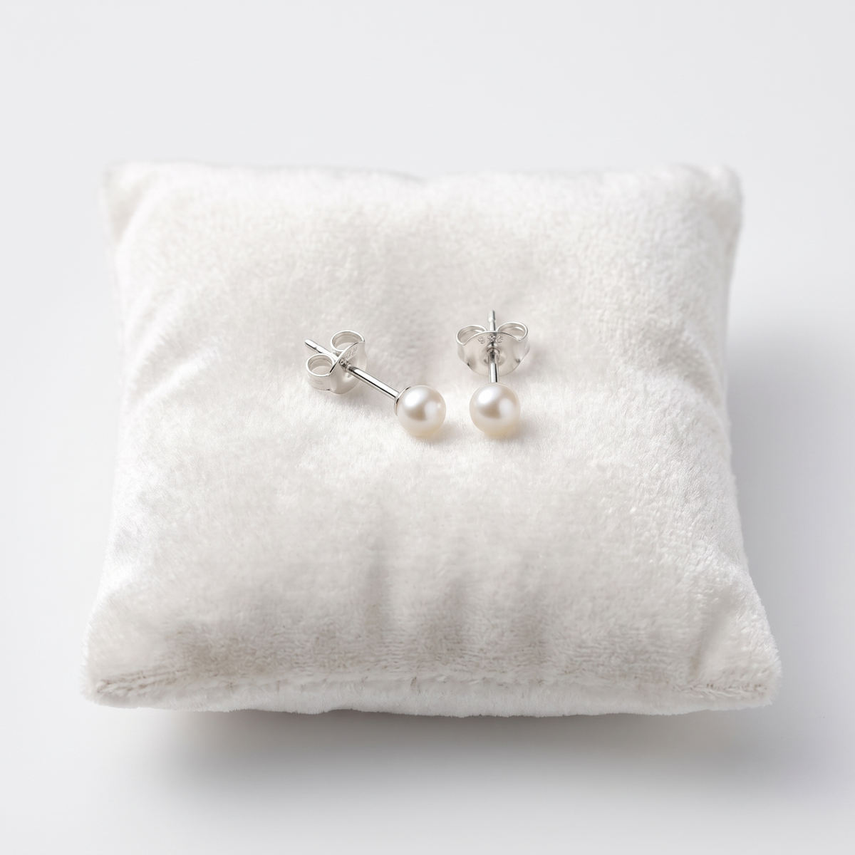 Kids Sterling Silver White Pearl Stud Earrings On Jewellery Cushion