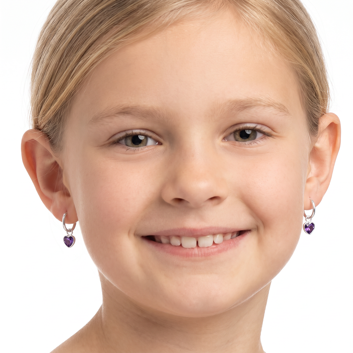 Close-up of purple amethyst-coloured heart cubic zirconia charms on silver hoop earrings