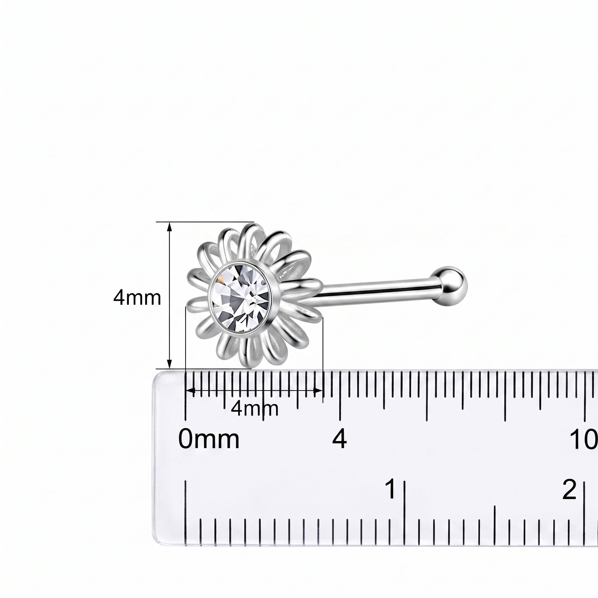 A silver-toned flower-shaped nose stud with a clear central gemstone, shown above a ruler with measurement markings indicating a 4mm size.