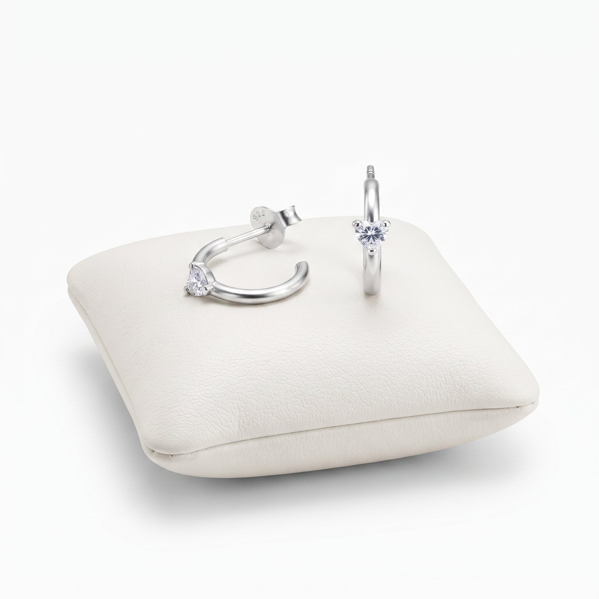 A pair of silverhoop ea rrings with clear gemstones