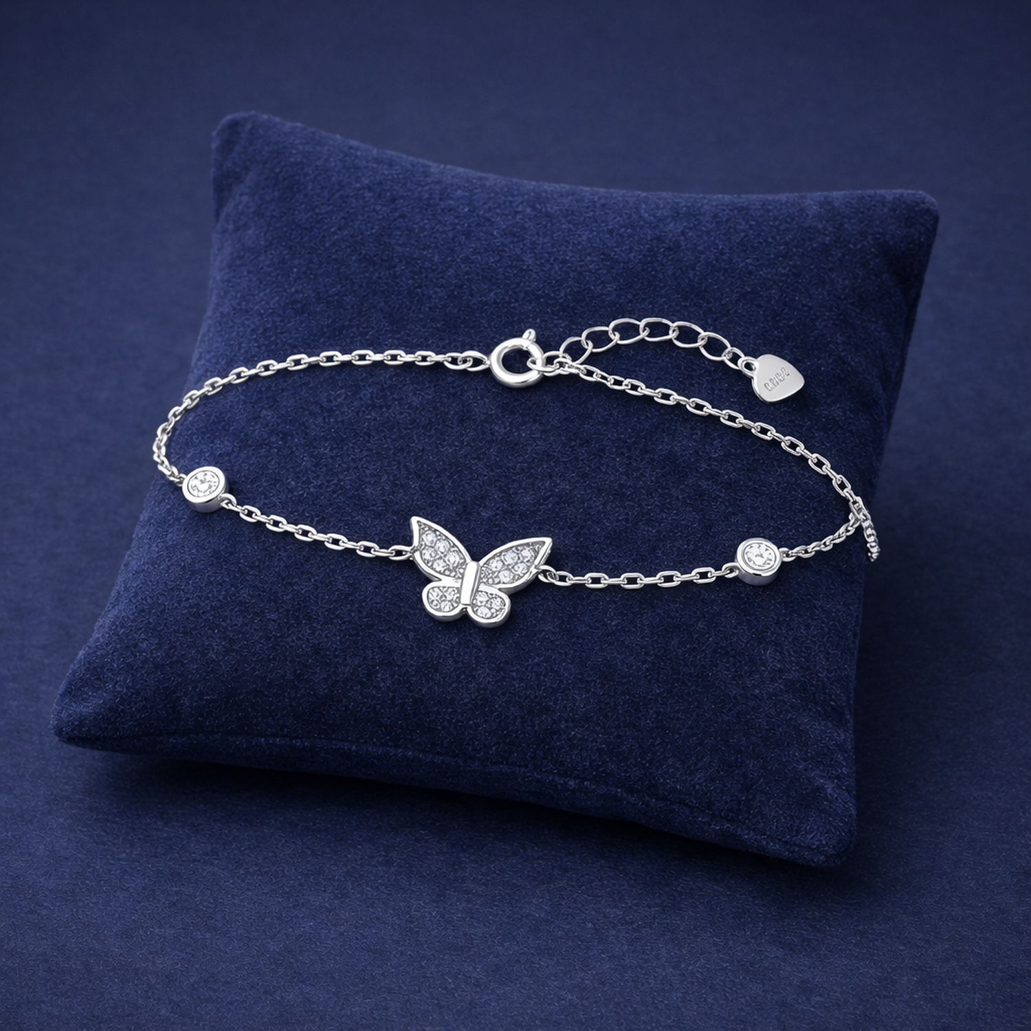 Melchior Jewellery womans sterling silver butterfly charm bracelet on navy cushion
