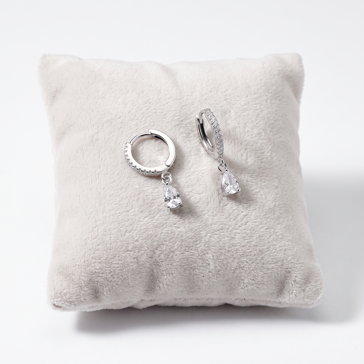Close-up of sterling silver white CZ teardrop birthstone earrings