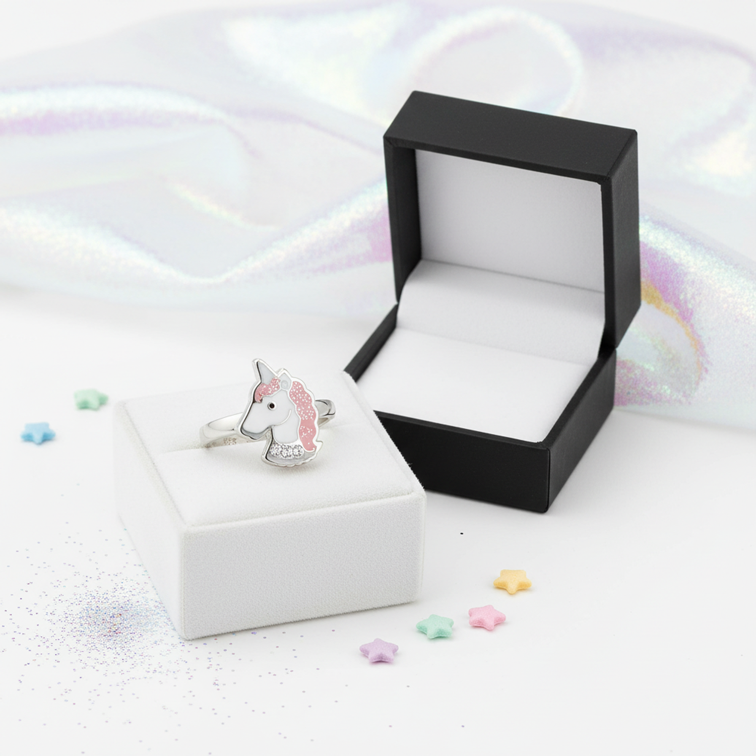 Melchior Jewellery adjustable unicorn ring for kids with pink mane displayed on white and black ring boxes