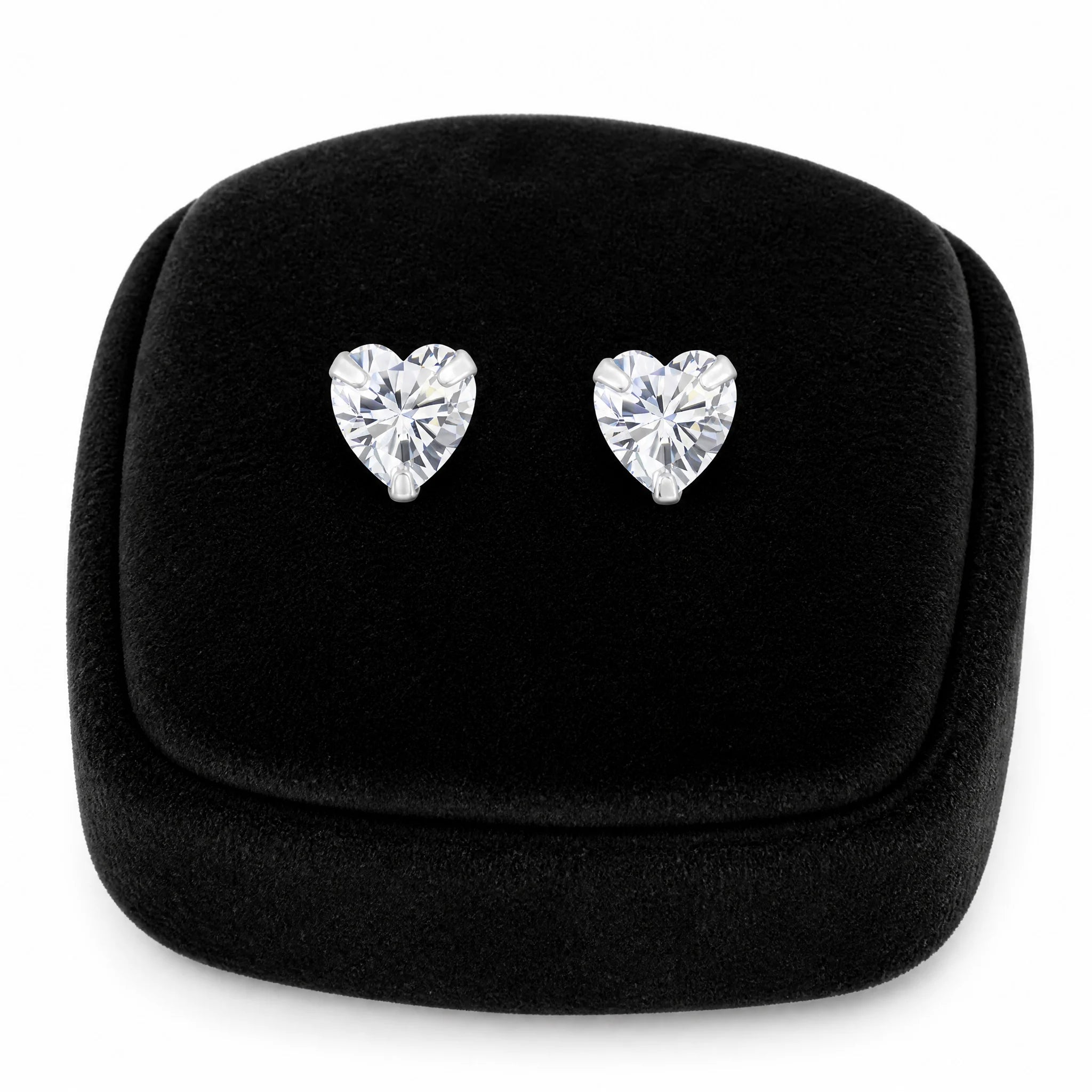 Sterling silver girls 6mm CZ heart screw back earrings displayed on a black velvet jewellery cushion