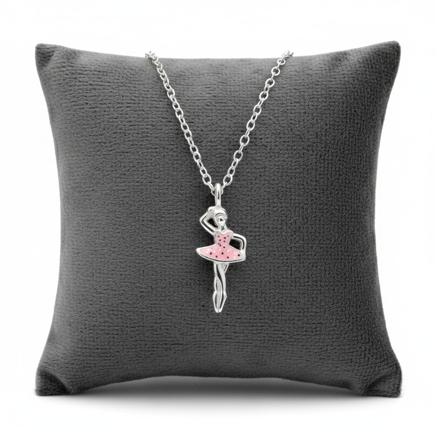 Silver girls ballet dancer necklace with pink enamel tutu on a silver chain displayed on a grey cushion by Melchior Jewellery