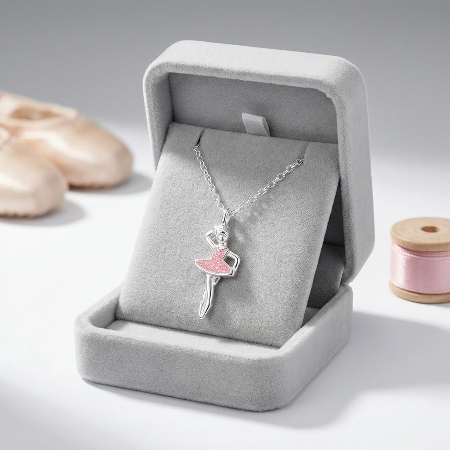 Silver girls ballet dancer necklace featuring a pink tutu pendant displayed in a grey velvet box by Melchior Jewellery