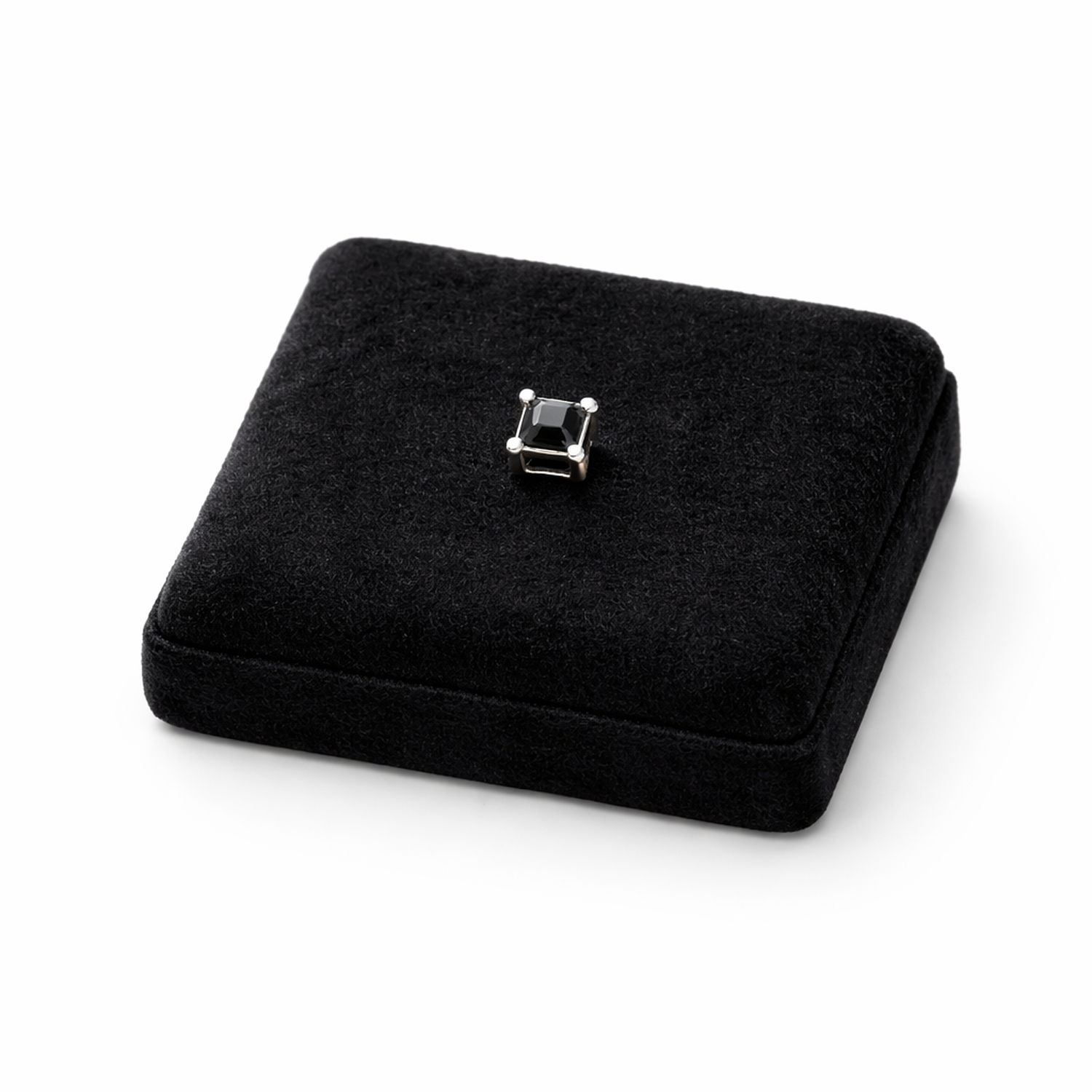 Black square stud earring for men from Melchior Jewellery displayed on black velvet cushion