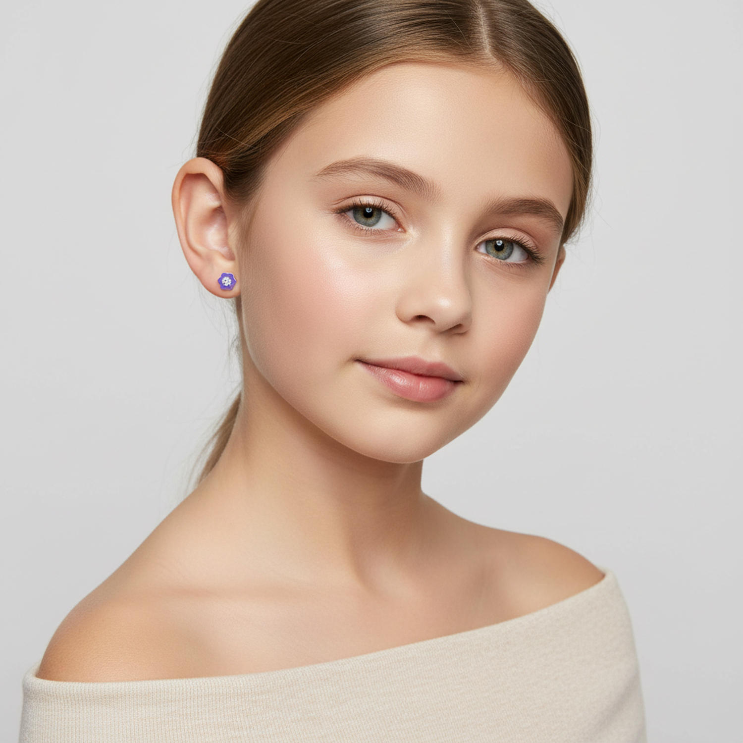 Young girl wearing purple CZ stud earrings for kids by Melchior Jewellery with simple and elegant design