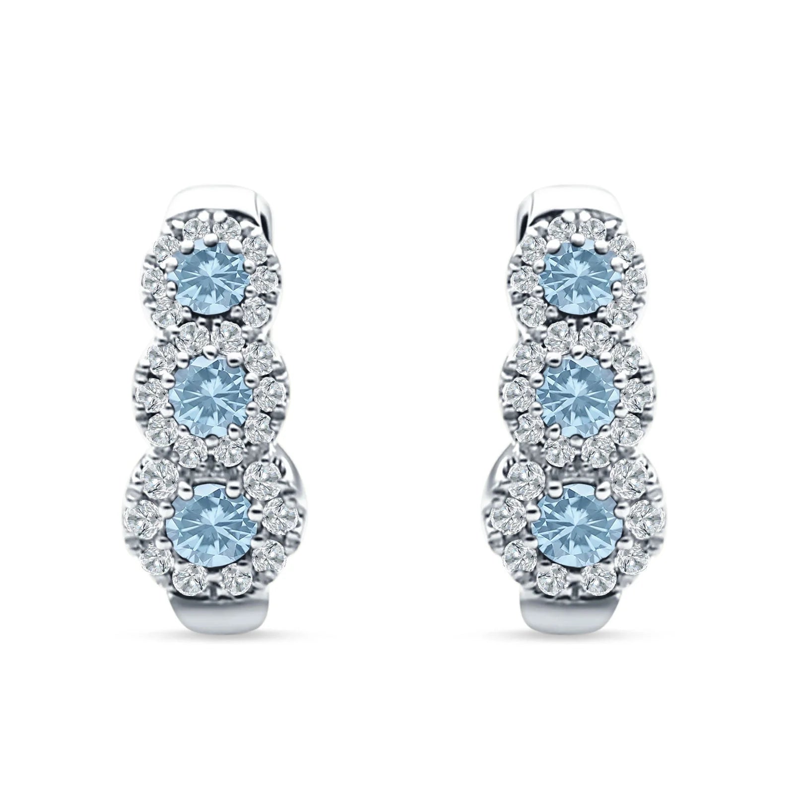 Melchior Jewellery silver huggie hoop earrings with triple blue gemstones surrounded by sparkling clear crystals