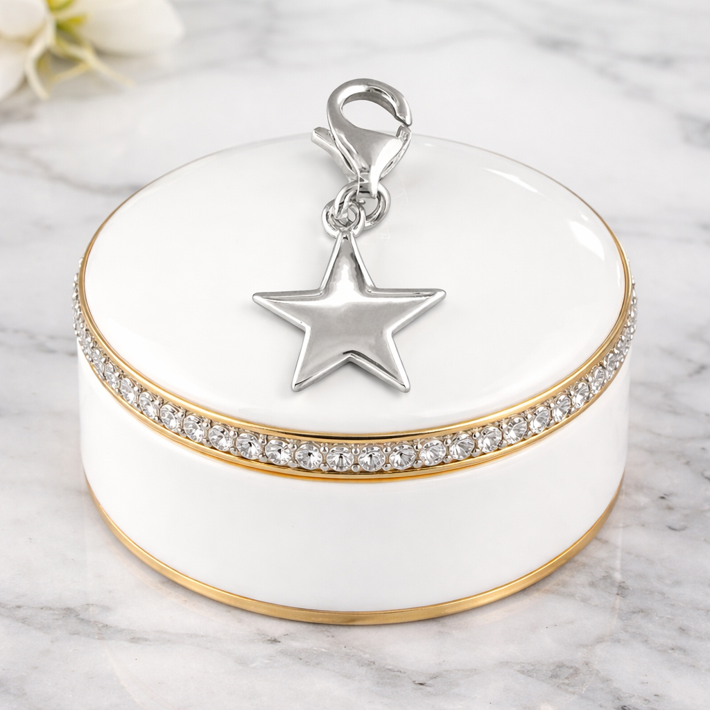 Silver Plain Star Clip On Charm in shiny polished silver resting on a white and gold decorative box