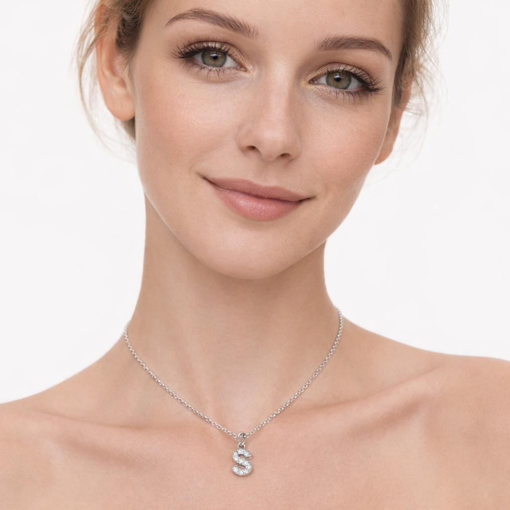 Silver Melchior Jewellery Alphabet Charm pendant in letter S with sparkling stones on a delicate chain worn by a woman