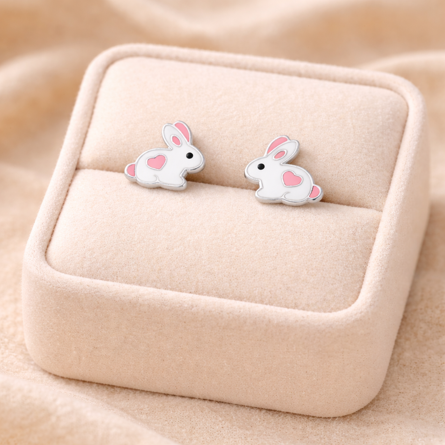 Sterling silver rabbit earrings for kids with pink heart details by Melchior Jewellery in beige display box