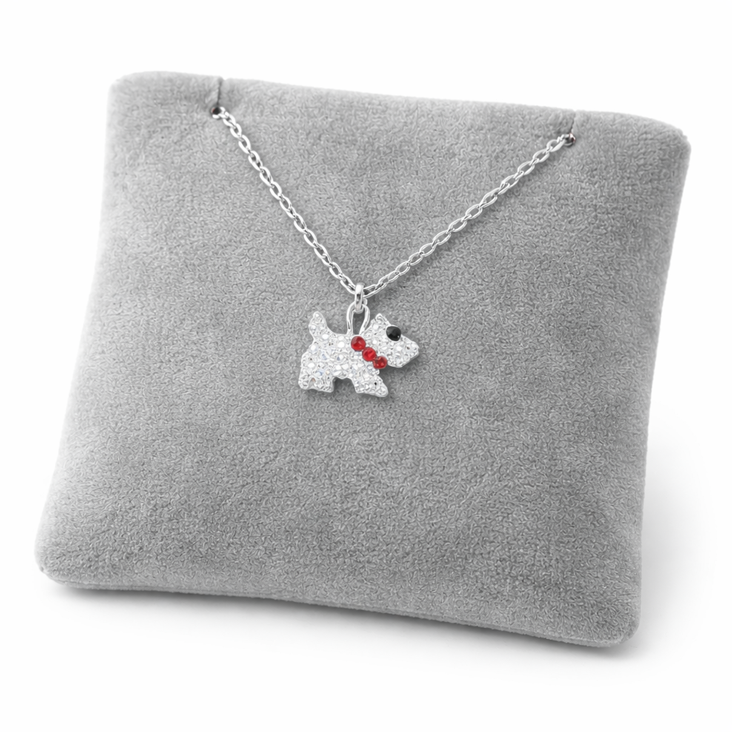 Kids crystal Scottie dog pendant necklace by Melchior Jewellery on silver chain displayed on grey cushion