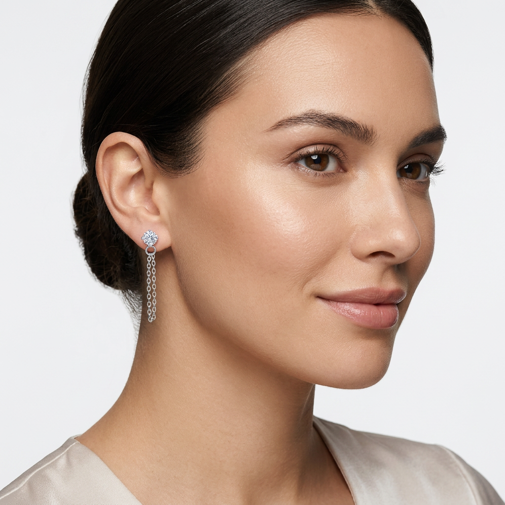 Sterling silver chain drop earrings worn by woman with smooth skin and dark hair tied back