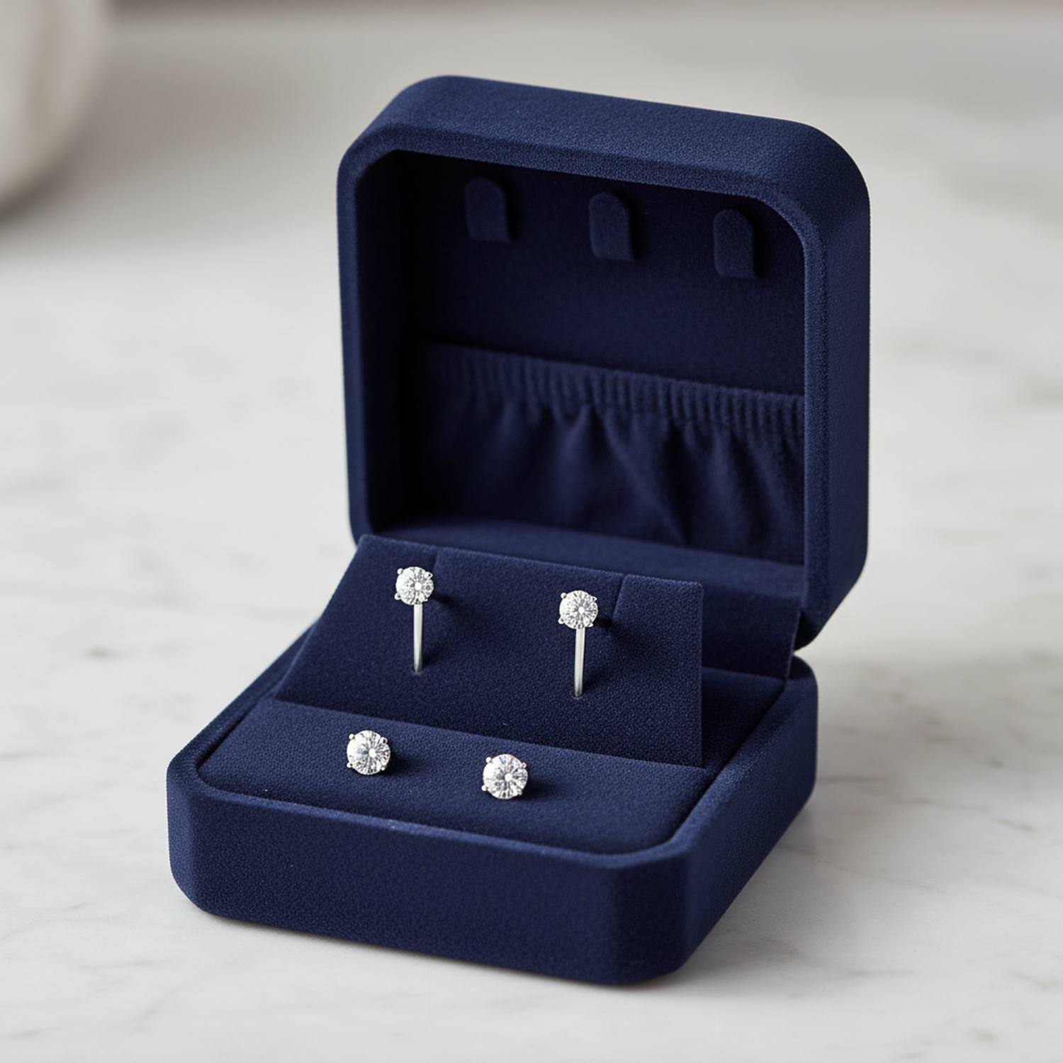 Melchior Jewellery sterling silver cubic zirconia stud earrings displayed in a navy blue velvet jewellery box
