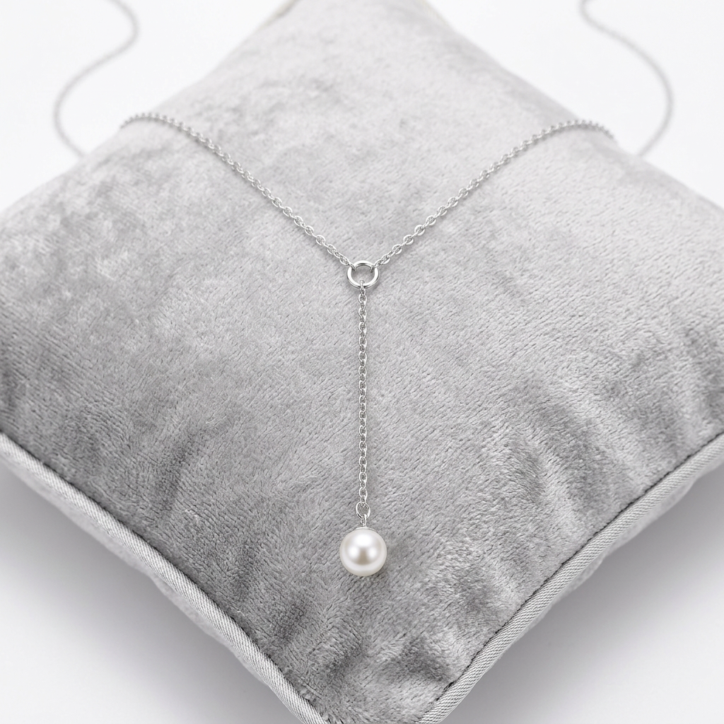 Elegant Pearl Necklace featuring a delicate silver chain and a single pearl pendant.