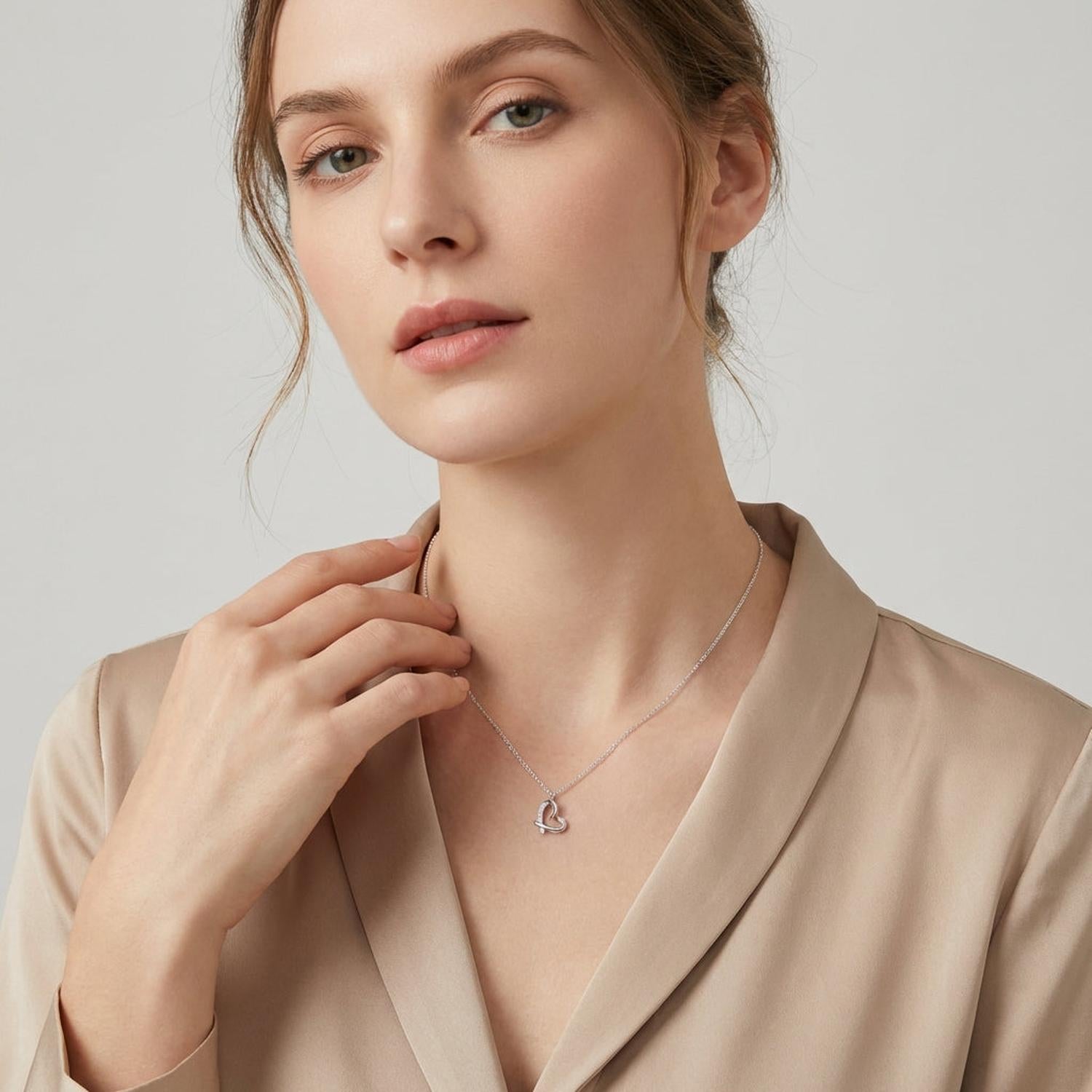 Melchior Jewellery woman wearing heart necklace with simulated diamonds on delicate silver chain