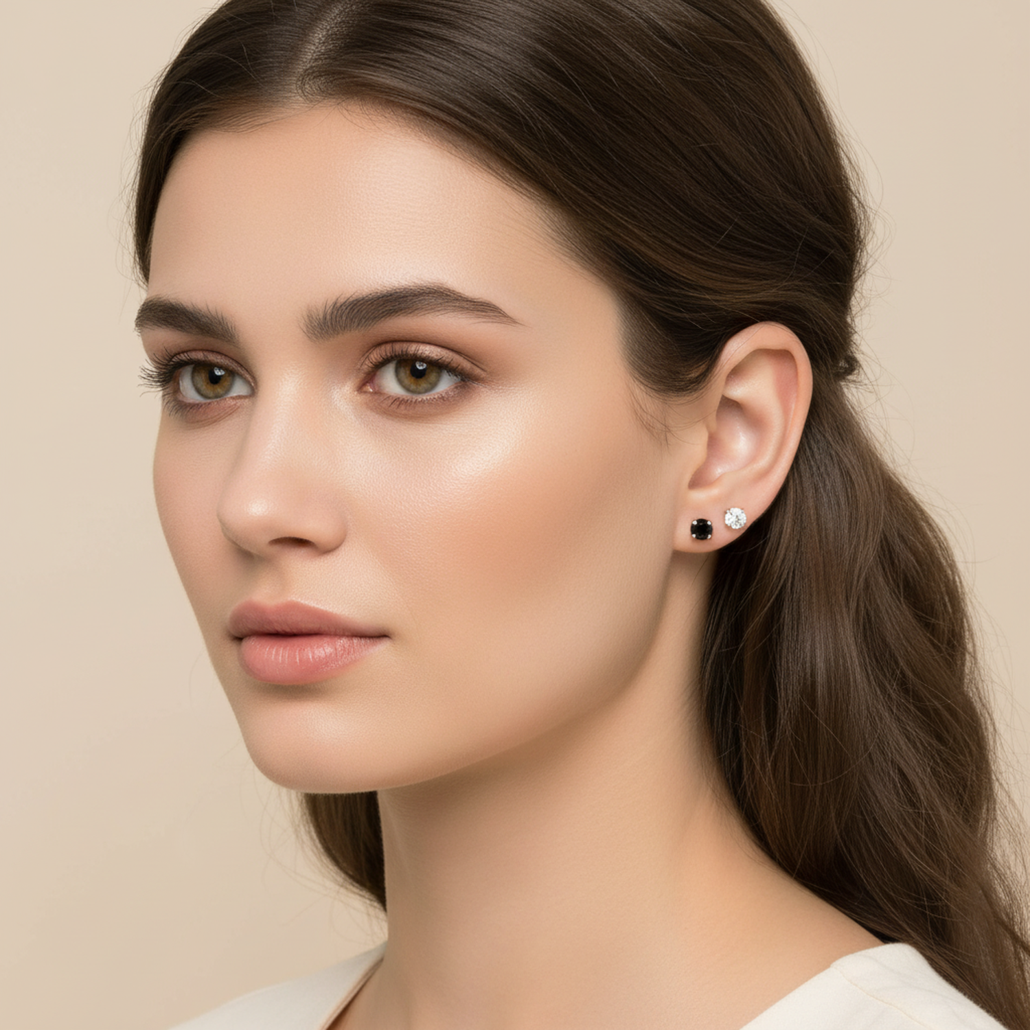 Melchior Jewellery tiny black and clear cubic zirconia earrings worn by woman with brown hair