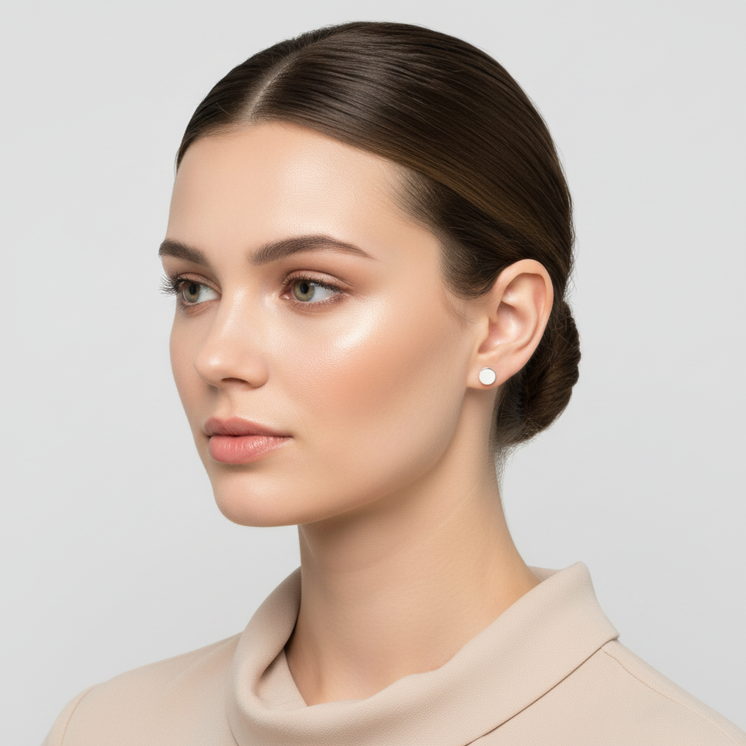 Melchior Jewellery sterling silver flat disc stud earrings worn by woman with sleek hairstyle