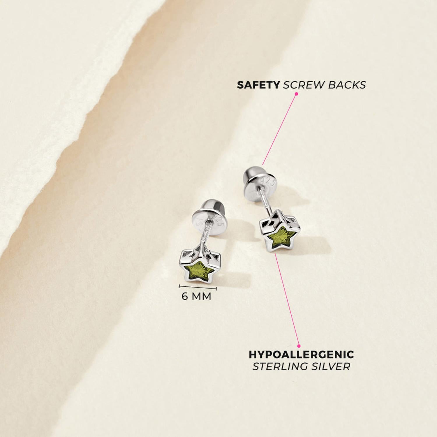 Sterling silver star-shaped children's earrings with green CZ stone and safety screw backs