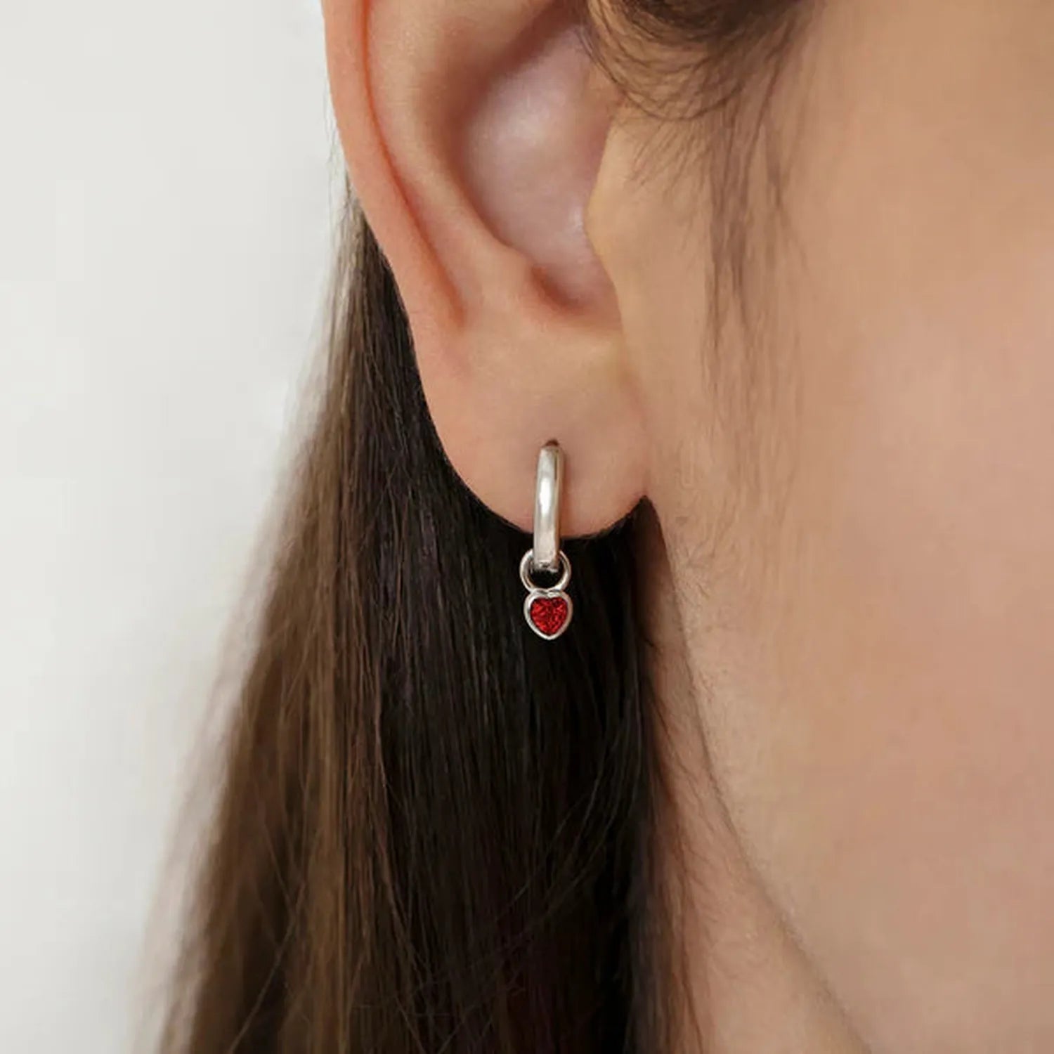 sterling silver heart-shaped January birthstone jewellery for children earrings in red by Melchior Jewellery