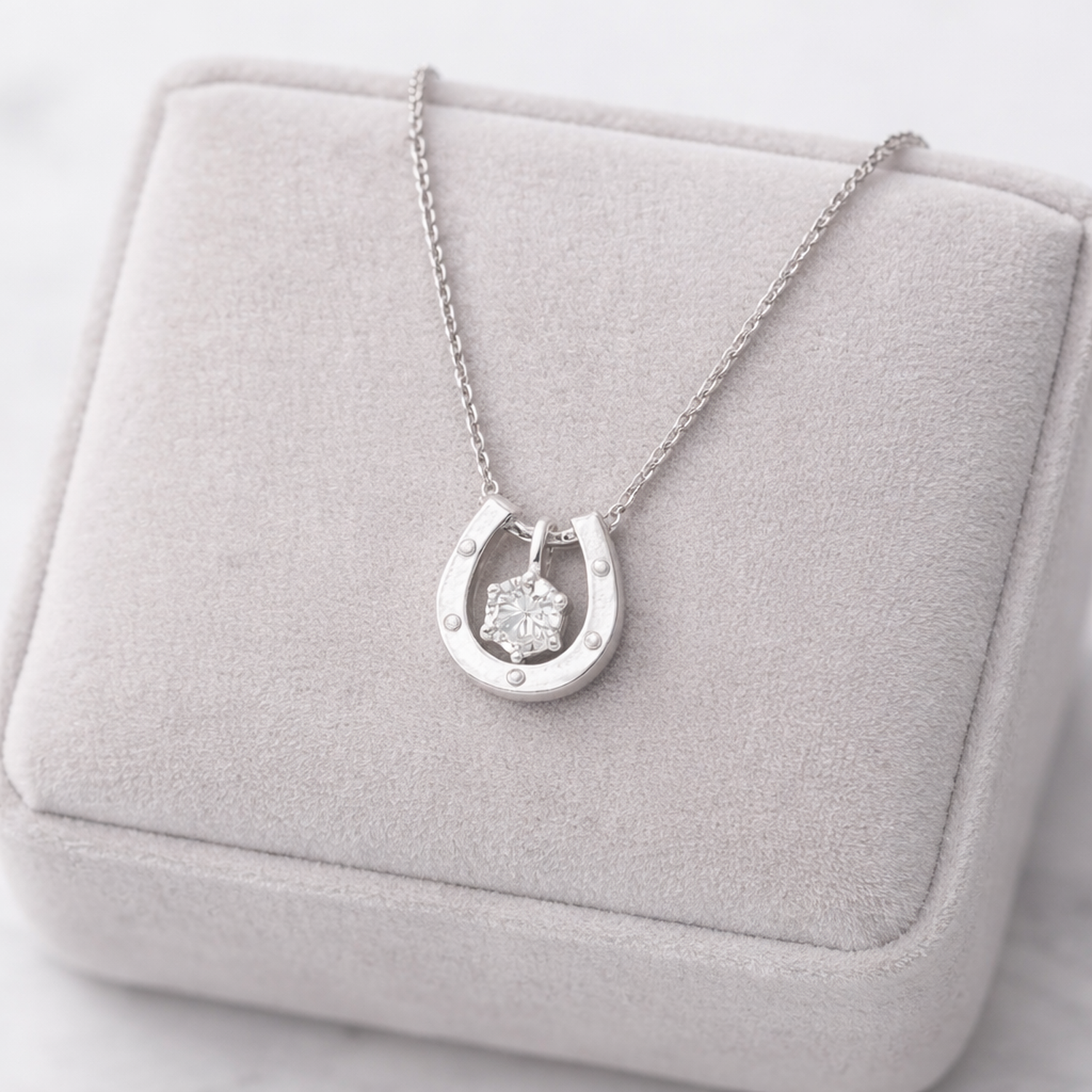Melchior Jewellery sterling silver horseshoe necklace with a sparkling central stone on a delicate chain
