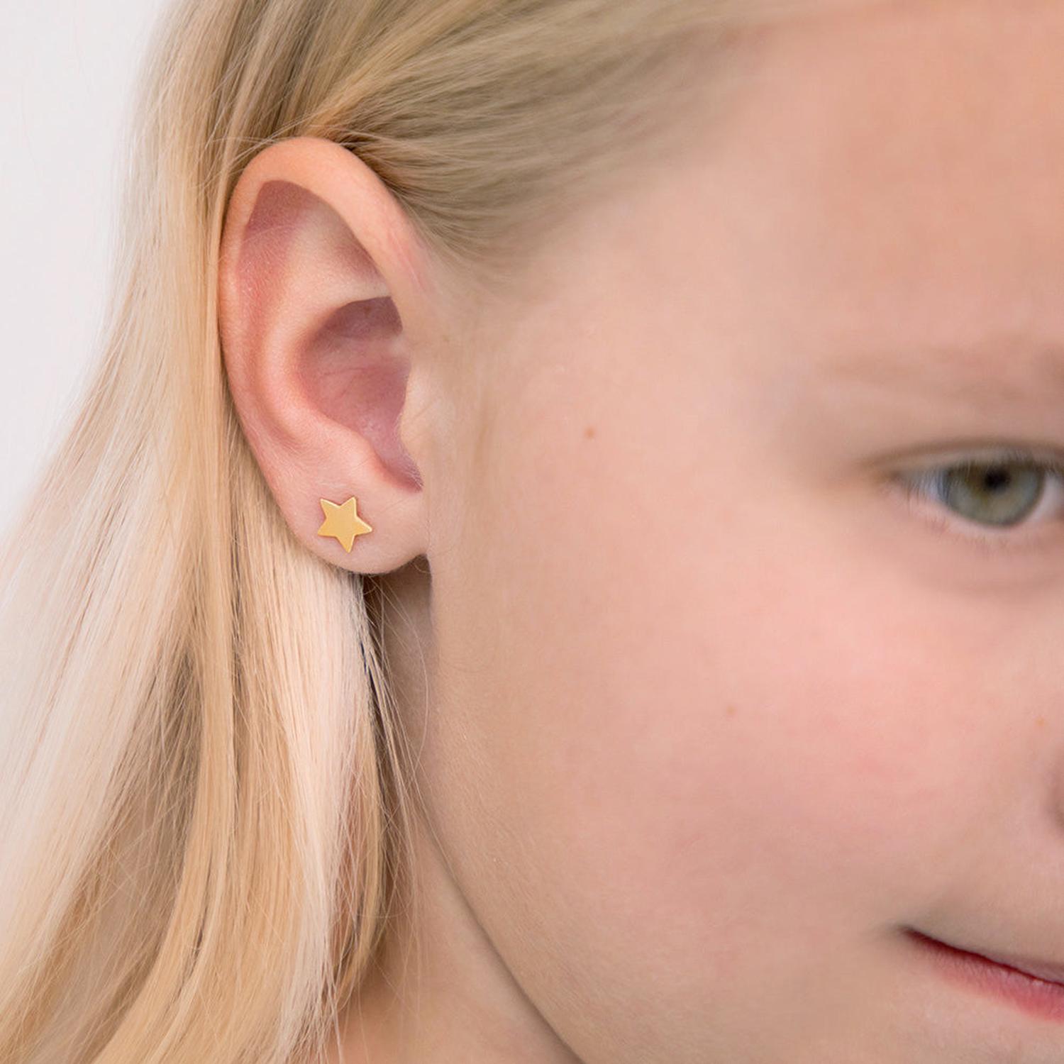14k gold star stud earrings for girls worn by a blonde child with fair skin from In Season Jewellery