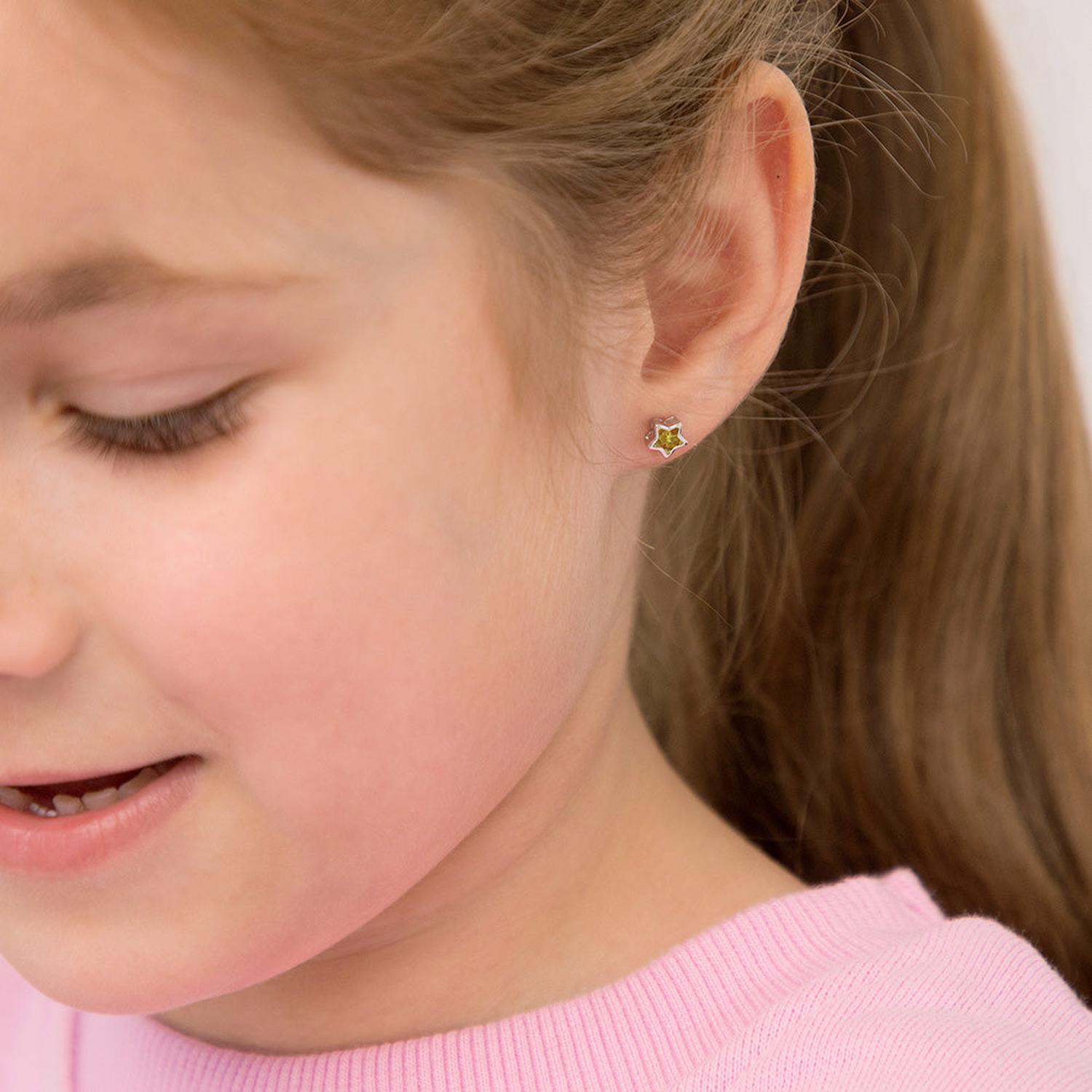 sterling silver green star kids November Birthstone Earrings worn by child in pink top