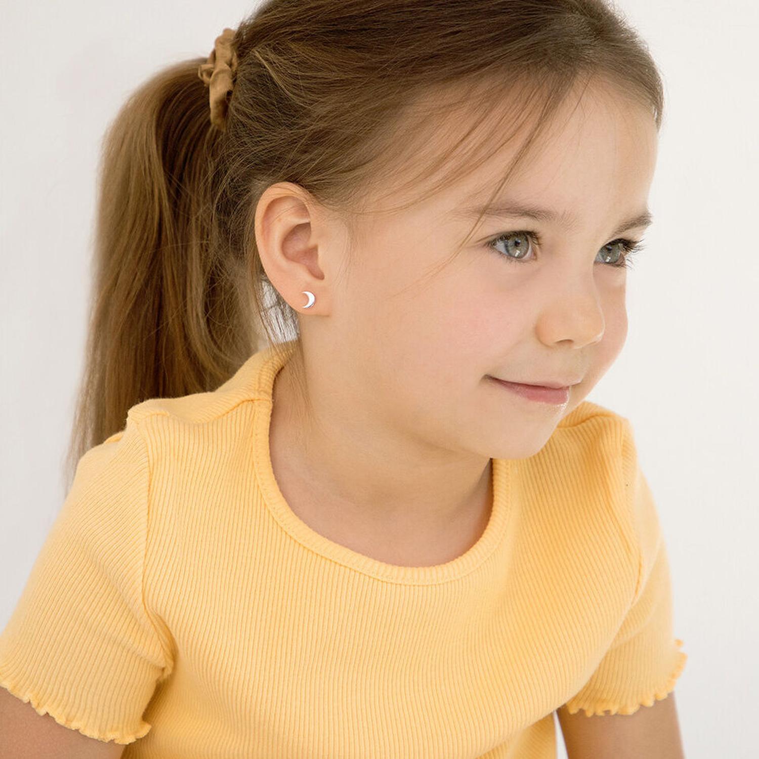 Sterling silver crescent moon girls earrings worn by child in yellow top from In Season Jewellery
