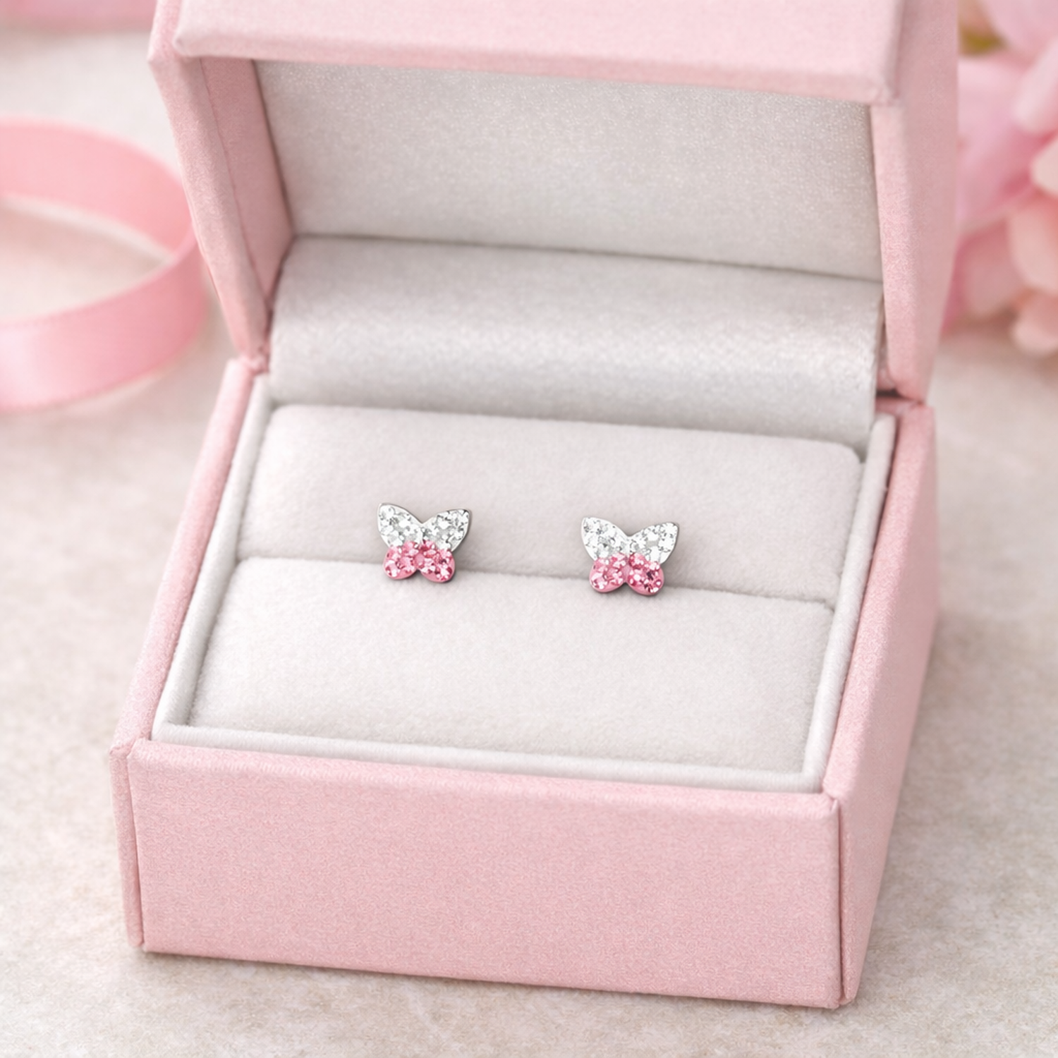 Melchior Jewellery kids butterfly earrings with crystals in pink and silver displayed in a pink velvet box