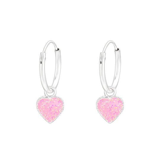 Kids silver heart charm earrings with pink glitter hearts on silver hoops by Melchior Jewellery