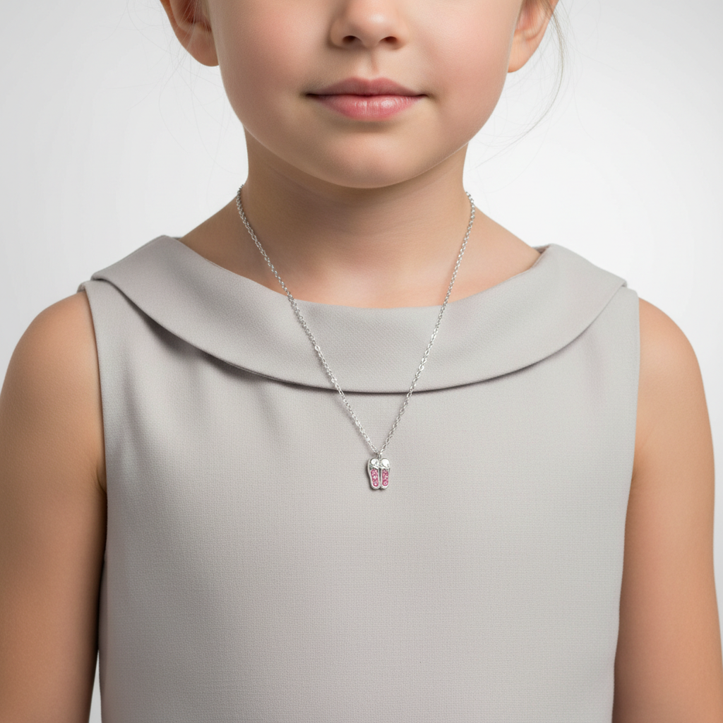 Pink crystal ballet shoes pendant for kids on silver chain worn by child from Melchior Jewellery