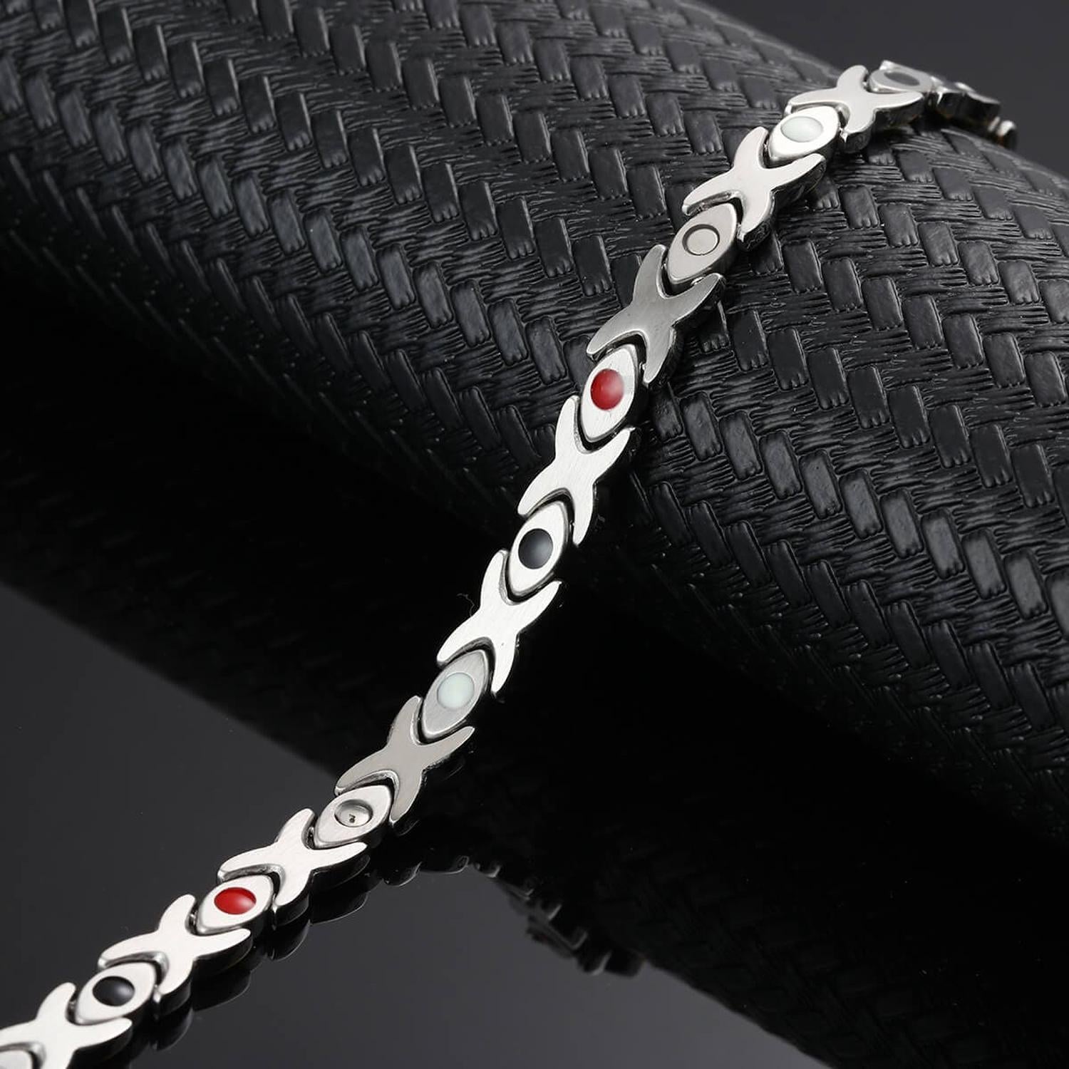 Melchior Jewellery 4in1 healing magnetic bracelet in silver with coloured magnetic elements on black textured background