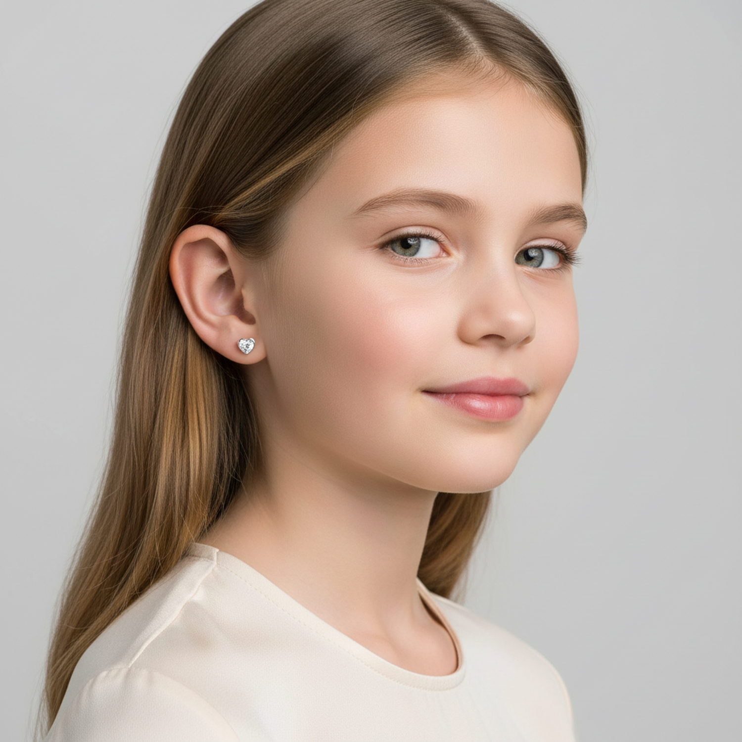 4mm heart earrings for girls worn by a young girl with straight hair from Melchior Jewellery