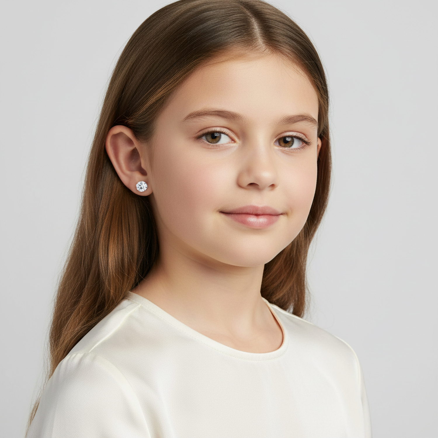 Girl wearing Melchior Jewellery 4mm screw back earrings for kids with clear gemstone studs