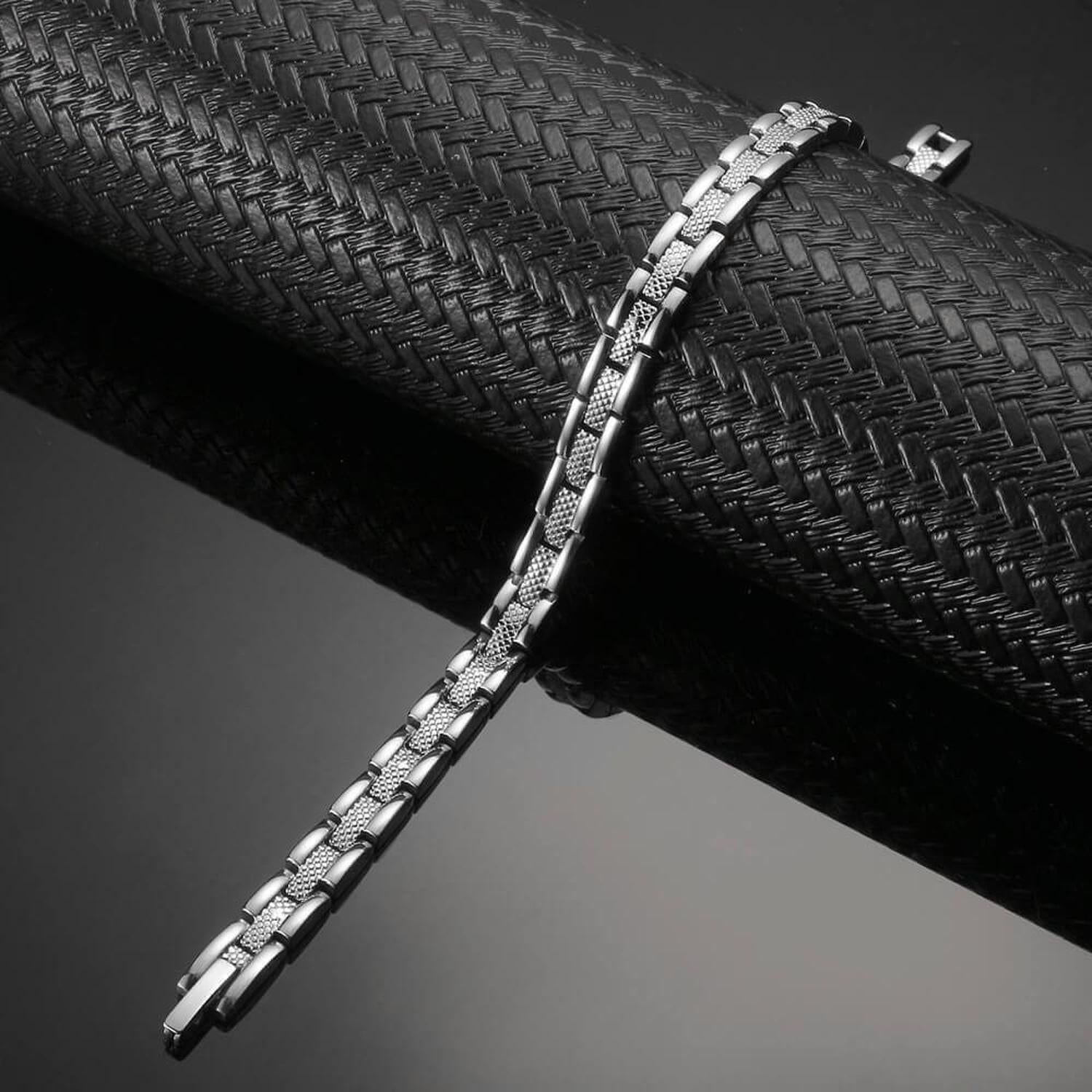 Affinity stainless steel 4 in 1 therapy bracelet by Melchior Jewellery with sleek silver links on black background