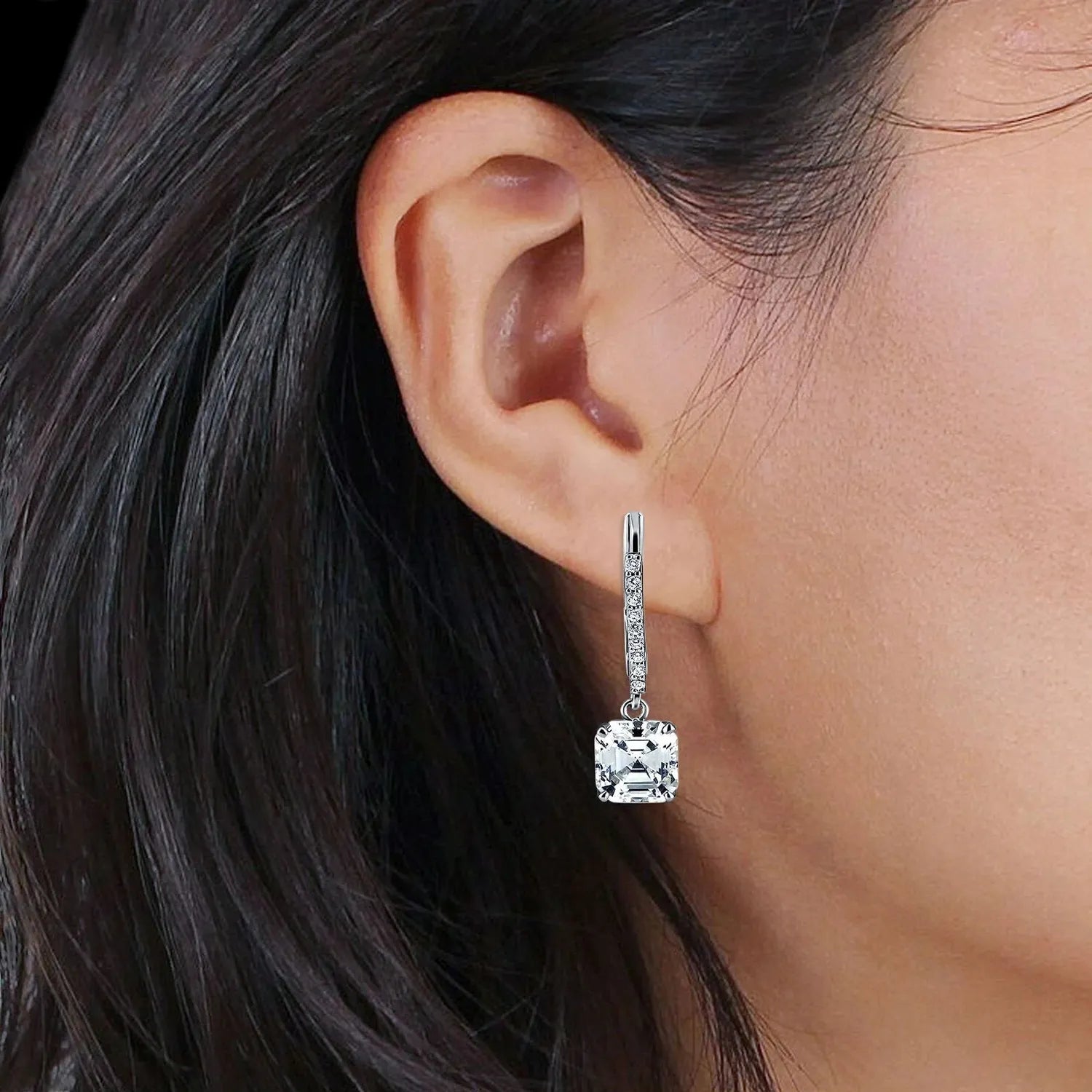 Melchior Jewellery Asscher Cut CZ Leverback Drop Earrings worn on a womans ear with silver detailing