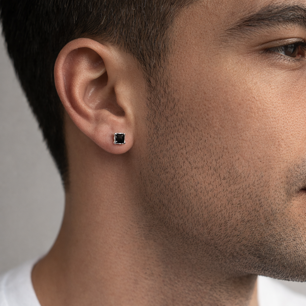 Close-up of a man wearing a black square stud earring for men by Melchior Jewellery