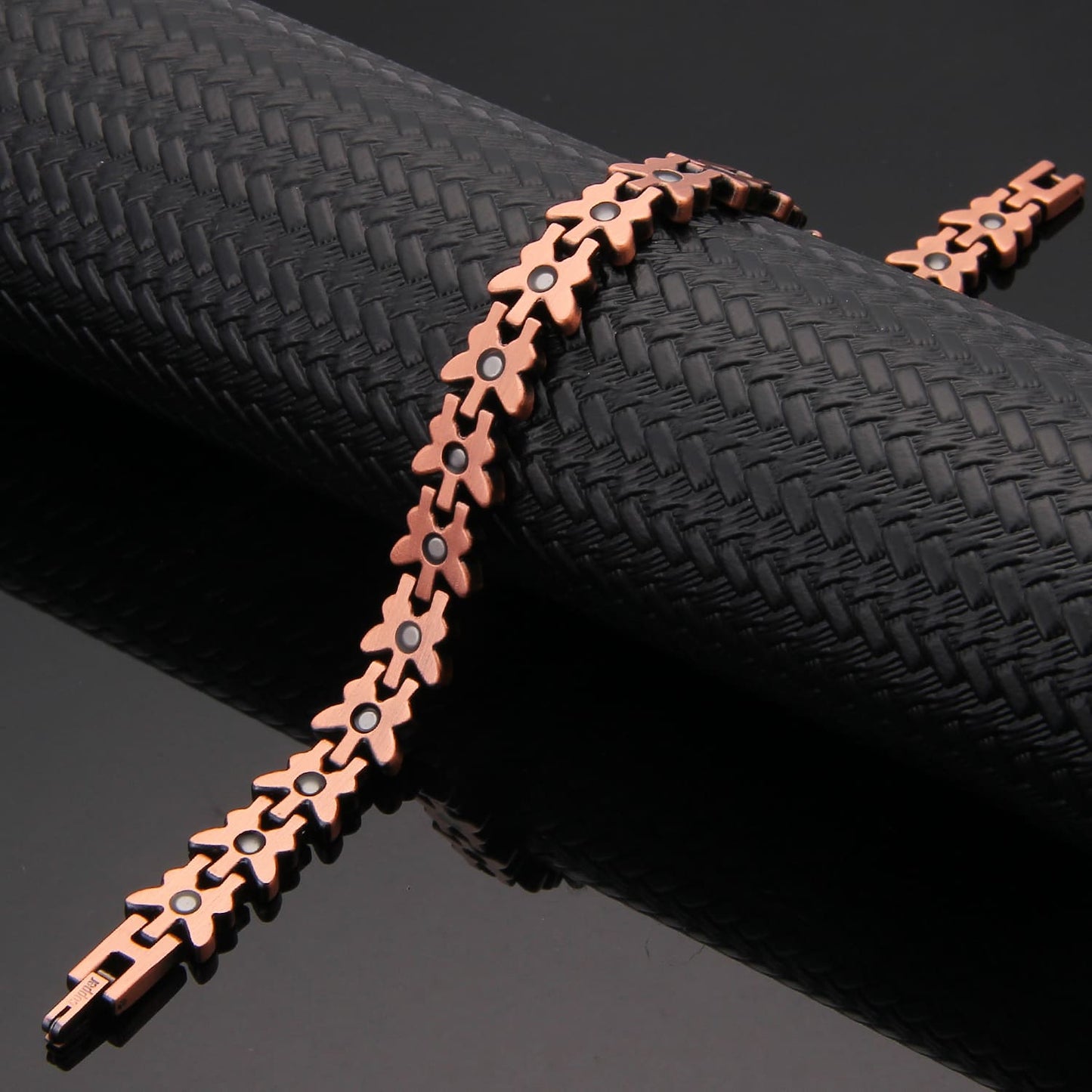 Melchior Jewellery copper butterfly design magnetic therapy bracelet with linked flower motifs and black magnets