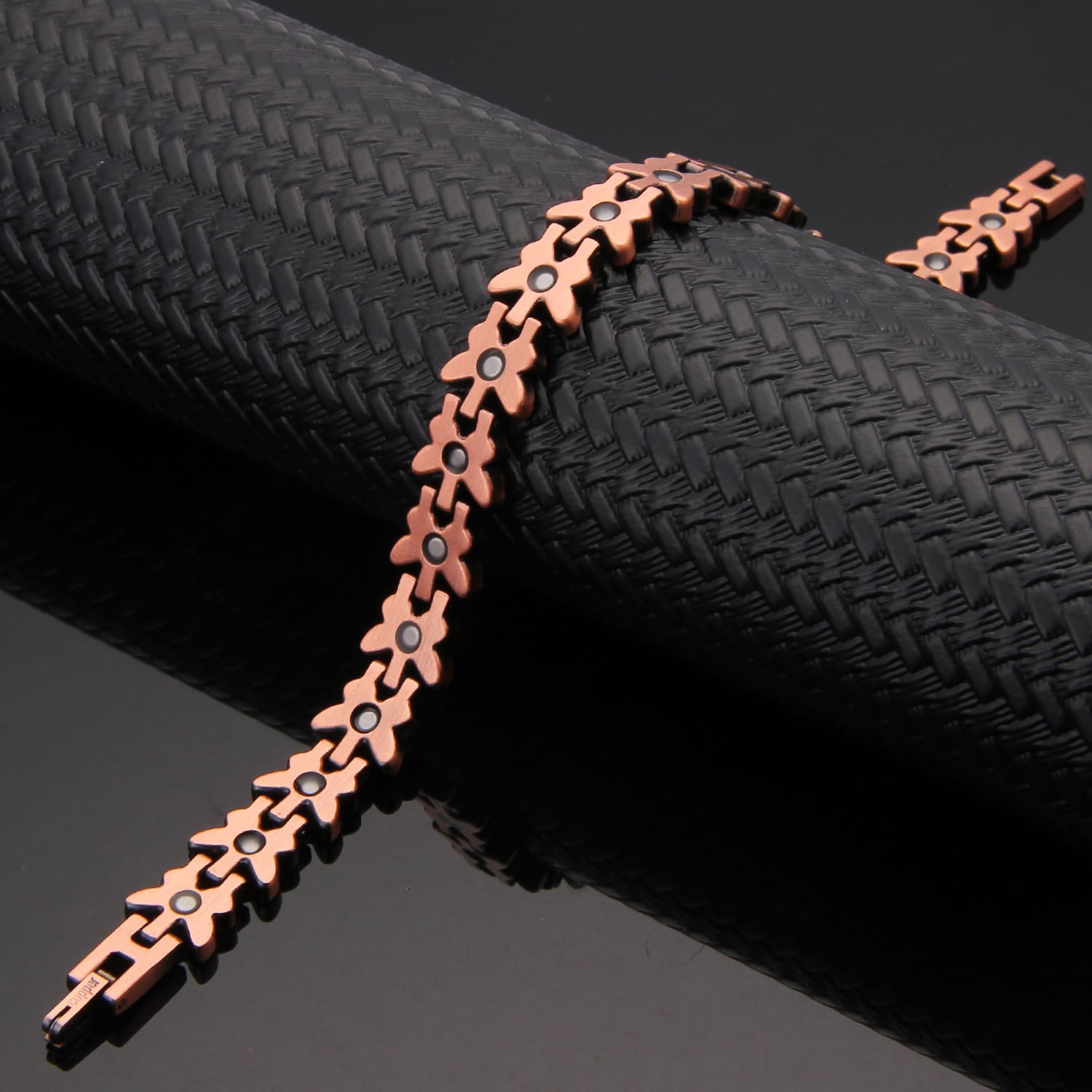 Melchior Jewellery copper butterfly design magnetic therapy bracelet with linked flower motifs and black magnets