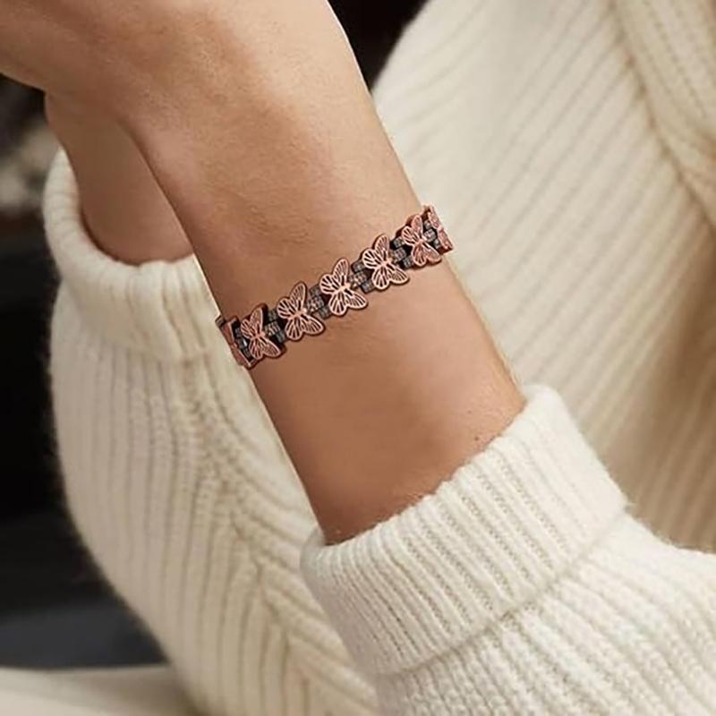 Melchior Jewellery copper butterfly design magnetic therapy bracelet on wrist showing floral link details