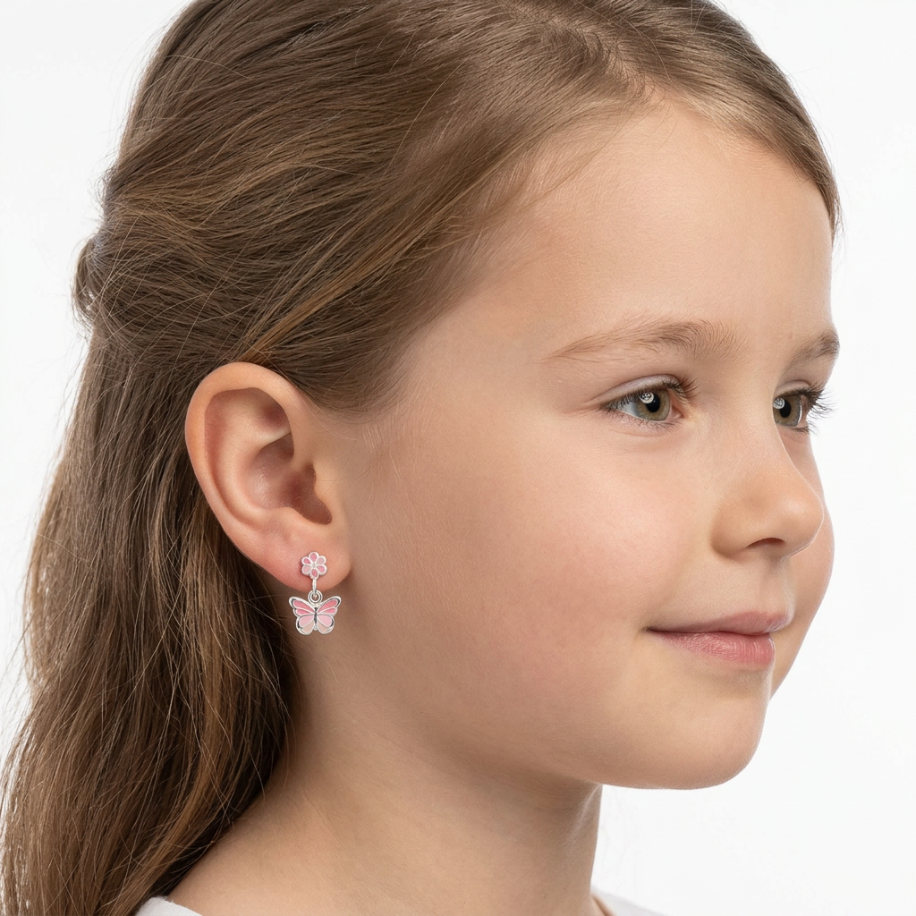 Melchior Jewellery butterfly drop earrings for girls in pink and silver on a young girl with brown hair