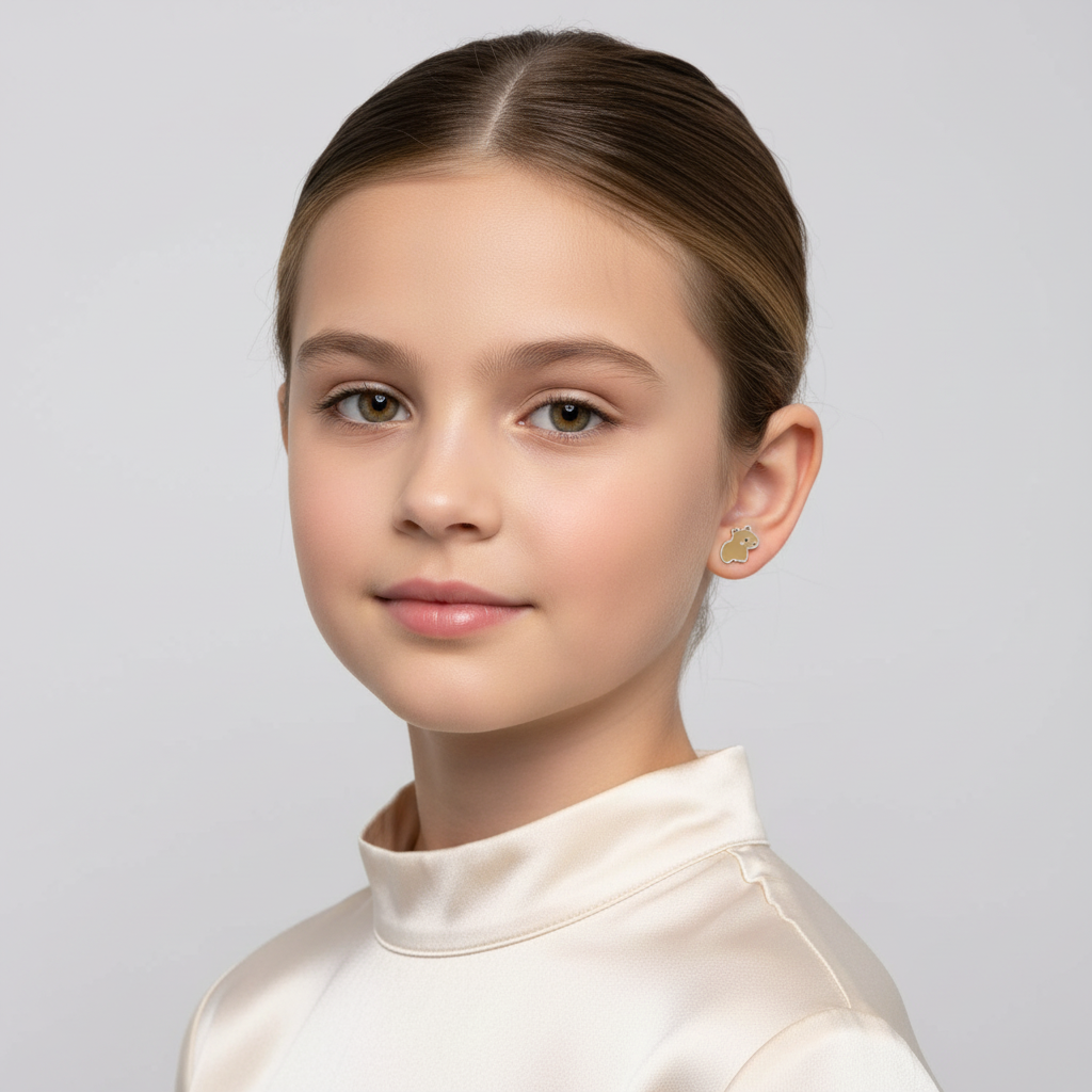 Young girl wearing Melchior Jewellery capybara earrings for girls with a cream satin top