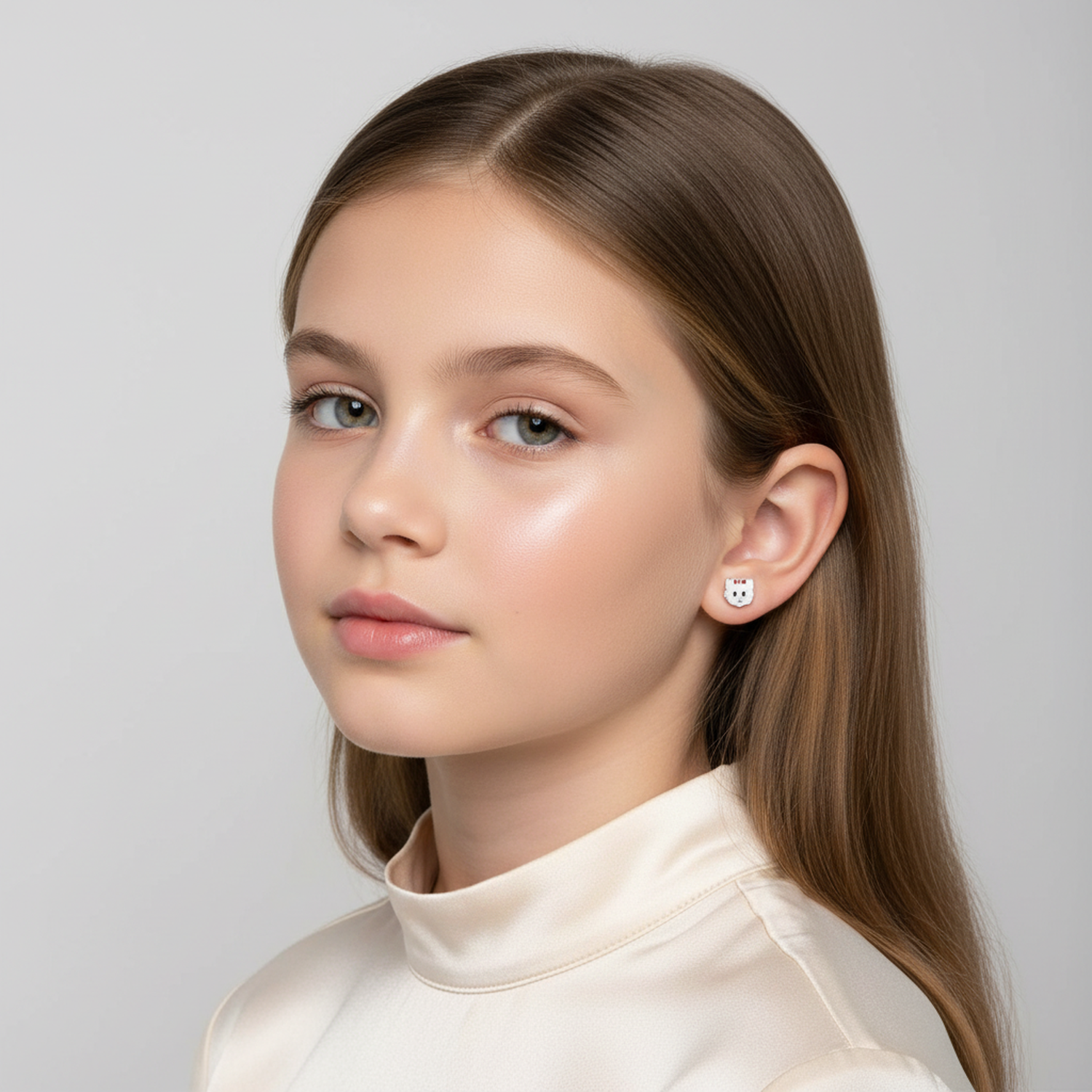 Melchior Jewellery cat earrings with red bow for children worn by girl with straight brown hair
