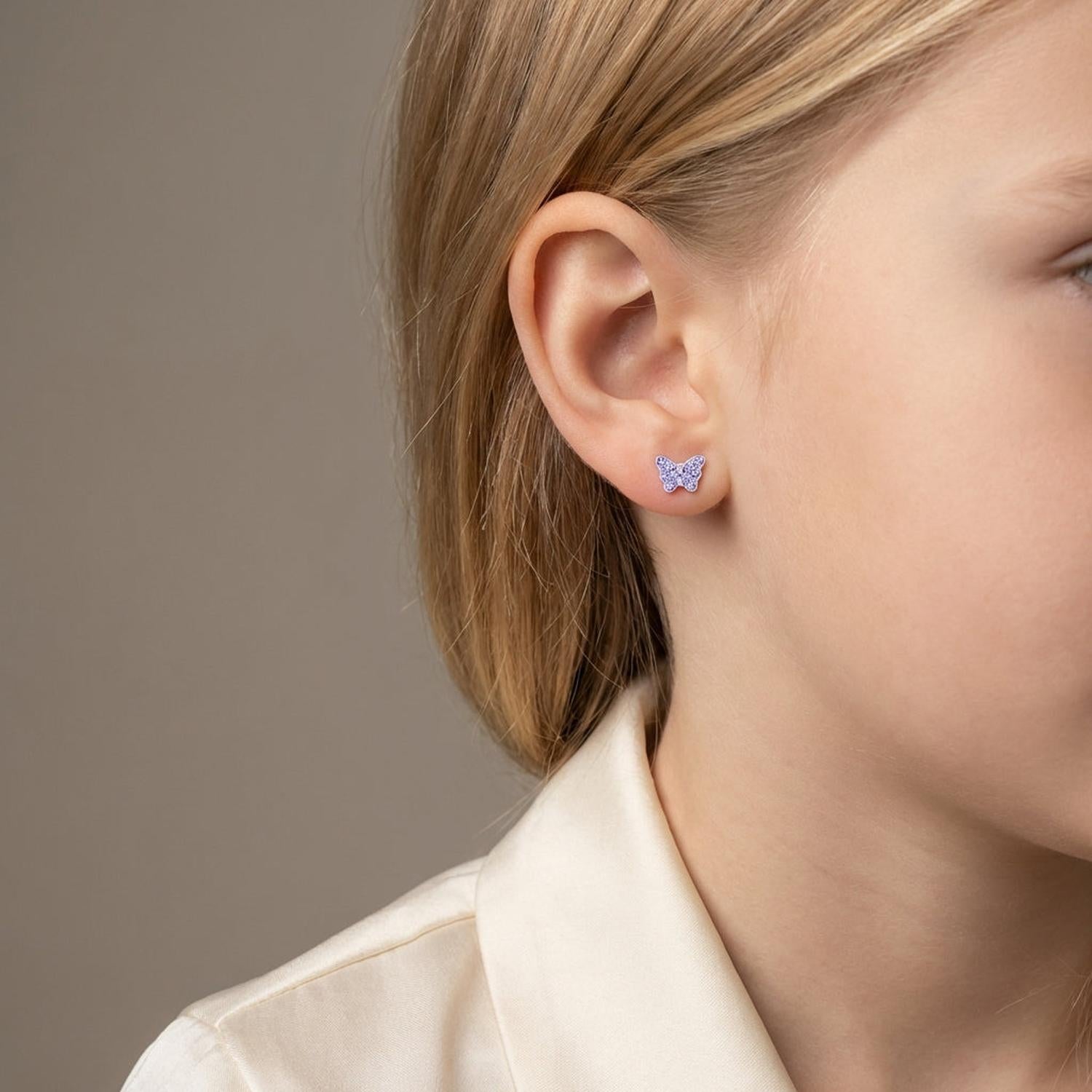 Melchior Jewellery crystal butterfly screw back earrings for kids worn by a child with blonde hair