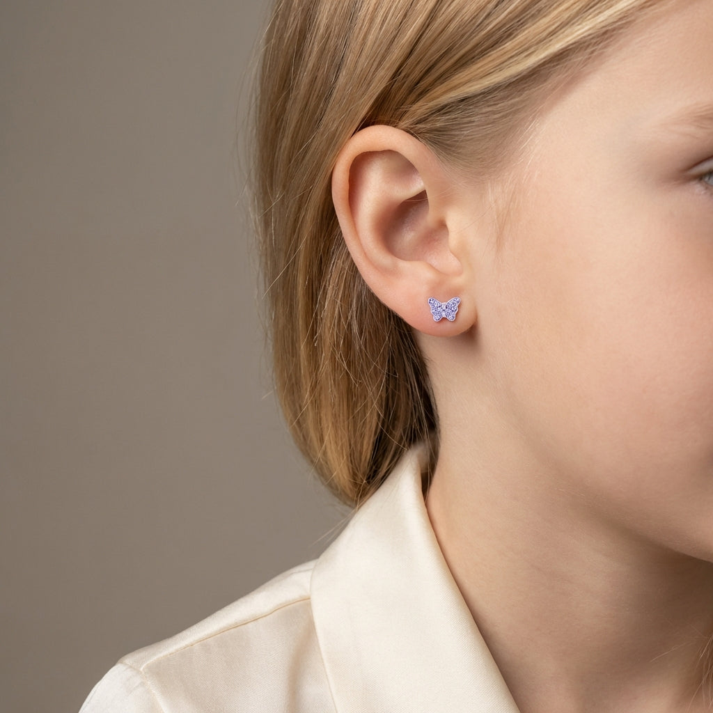 Melchior Jewellery crystal butterfly screw back earrings for kids worn by a child with blonde hair