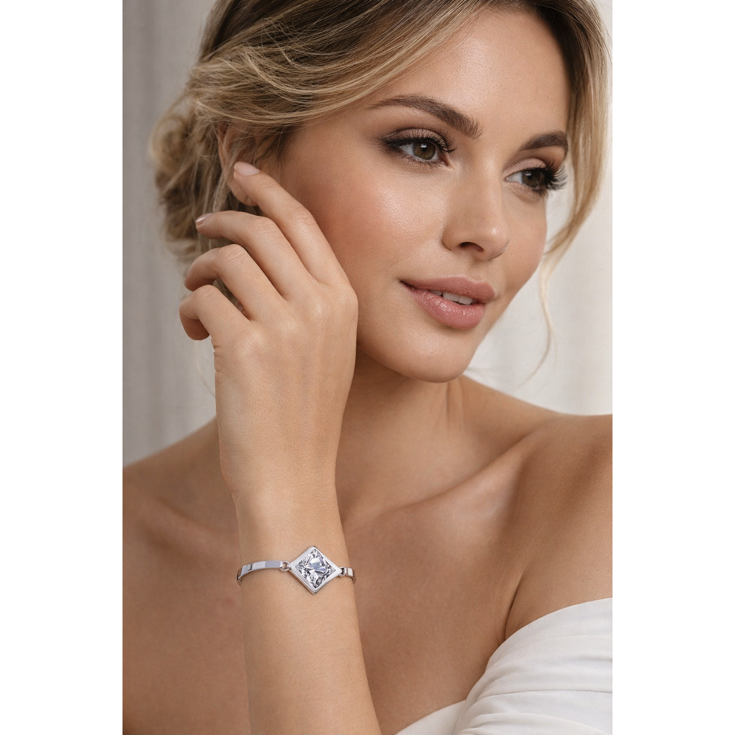 Sentiell woman's diamond shape cubic zirconia bracelet worn on wrist with elegant silver band