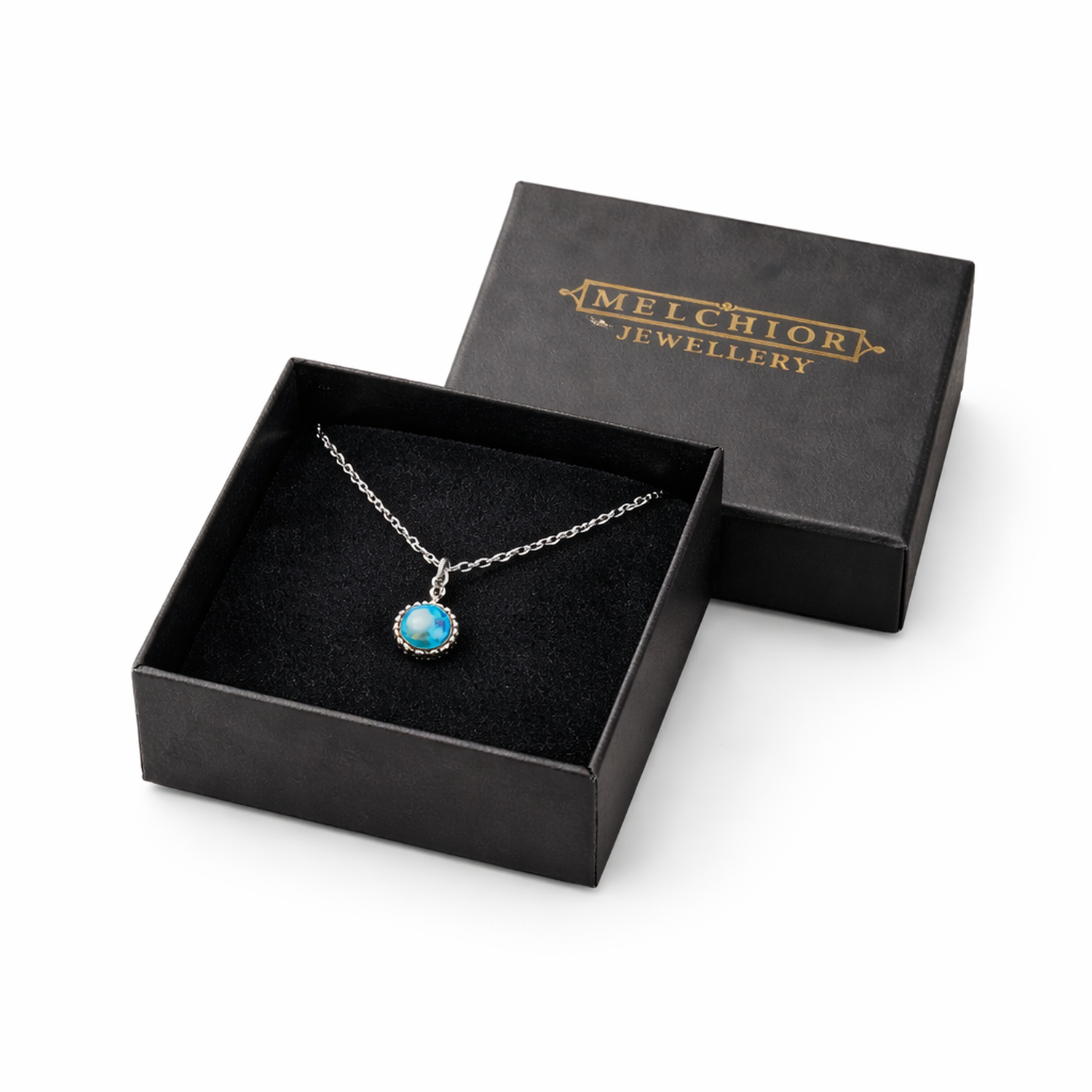 Elegant blue gemstone pendant necklace from Melchior Jewellery in black gift box with gold logo