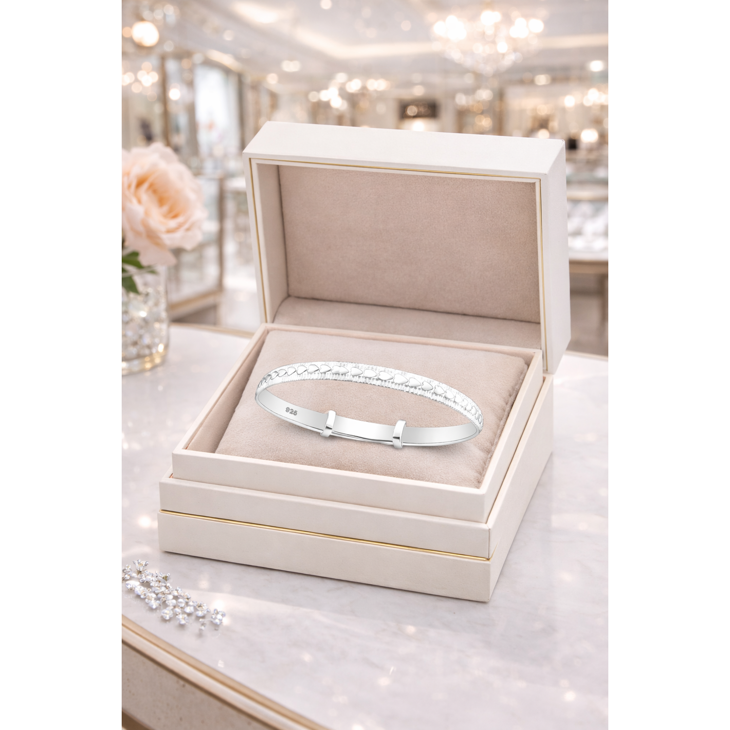 Melchior Jewellery expandable heart baby bracelet in silver displayed in a luxury cream jewellery box
